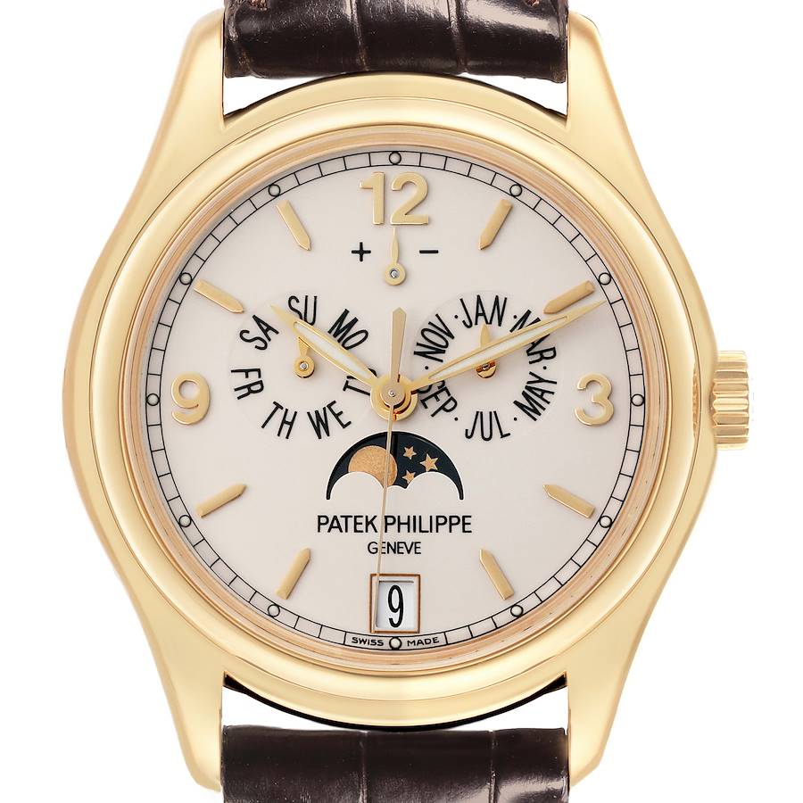 The Patek Philippe Complications watch is shown from the front, displaying its gold case, dial with calendar, moon phase, and leather strap.