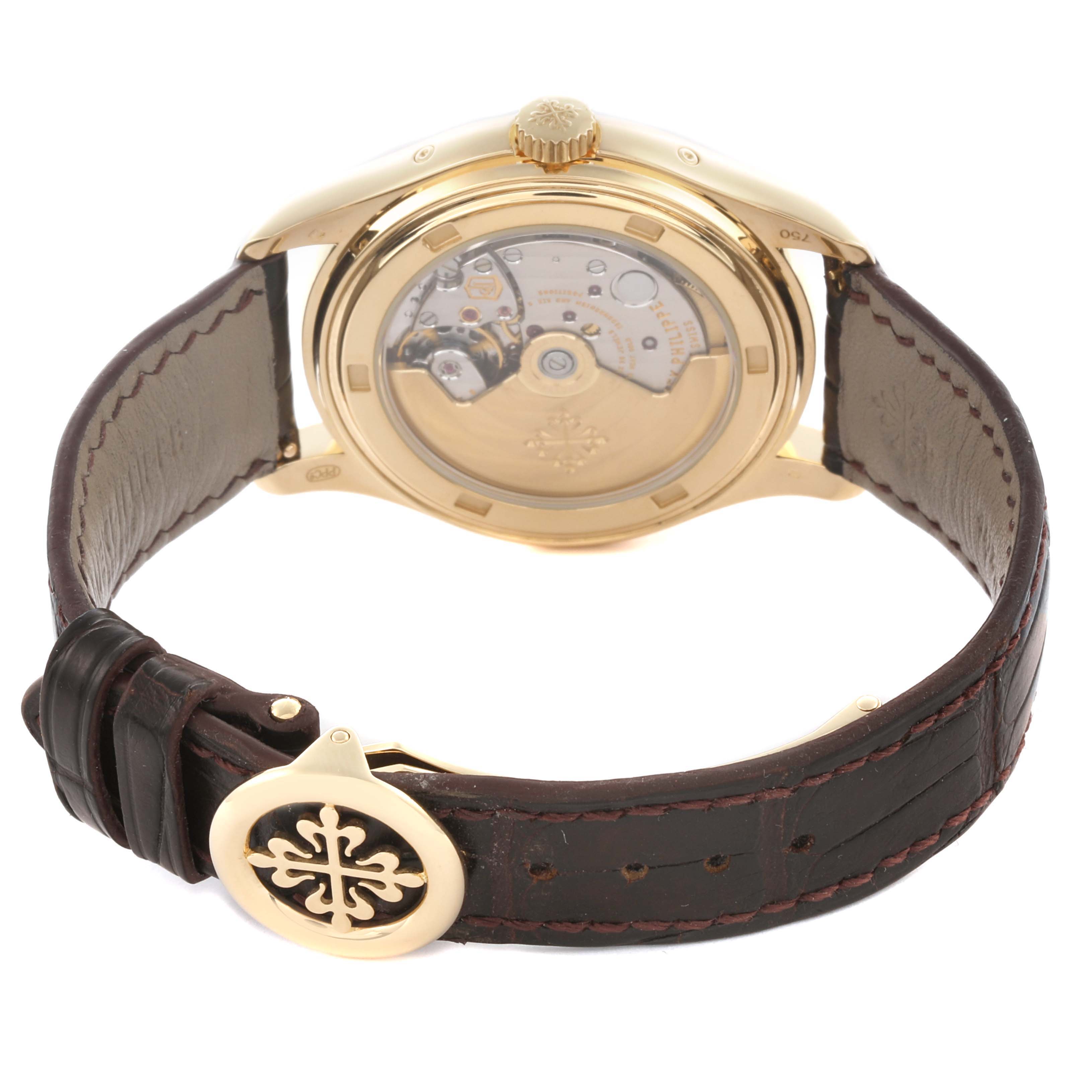 The image shows a rear view of the Patek Philippe Complications 5146J-001 Men's Yellow Gold White Dial 5146J-001 Men's Yellow Gold White Dial watch, highlighting its transparent case back and leather strap.