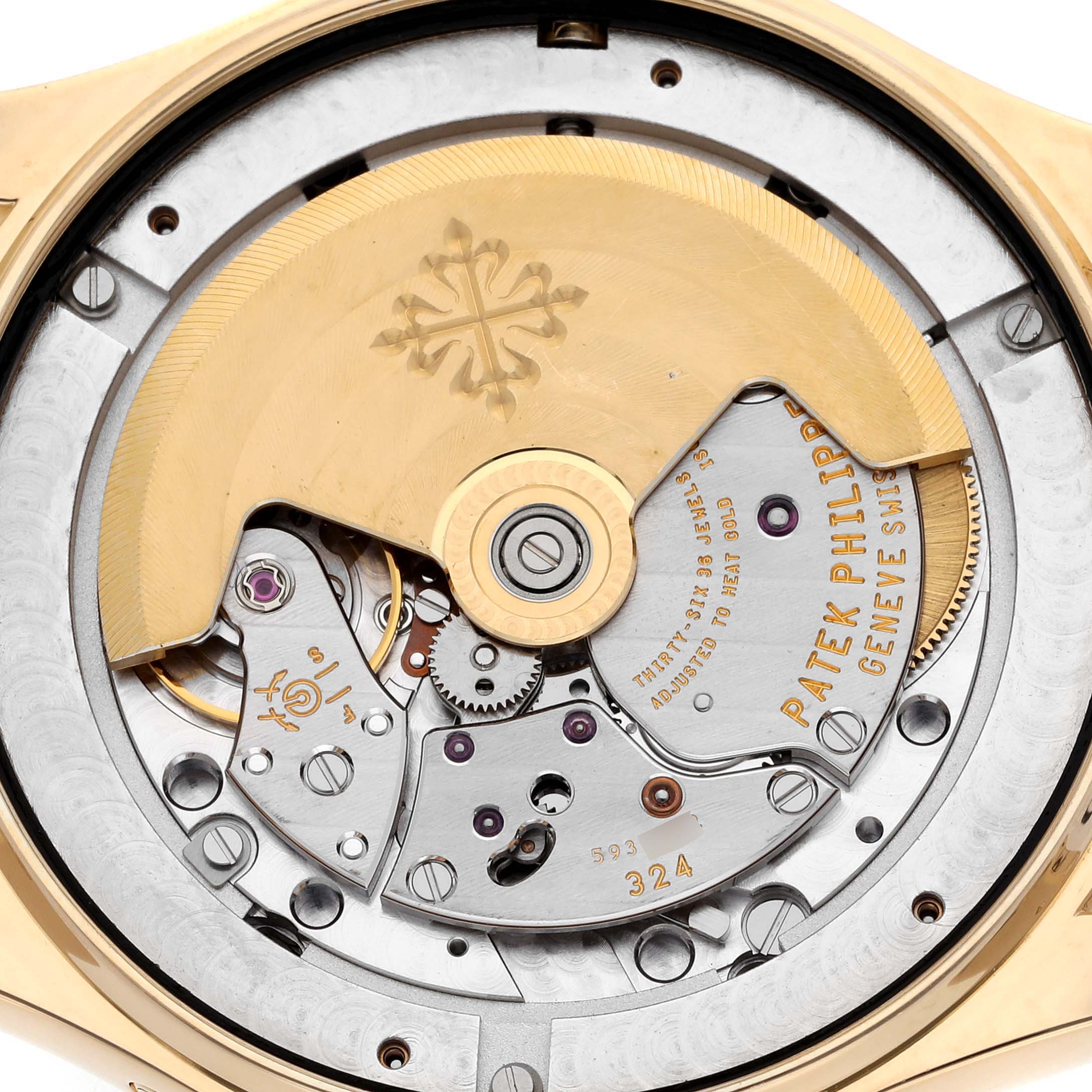 The image shows the movement of a Patek Philippe Complications 5146J-001 Men's Yellow Gold White Dial 5146J-001 Men's Yellow Gold White Dial watch from a rear angle, highlighting the rotor and intricate gears.