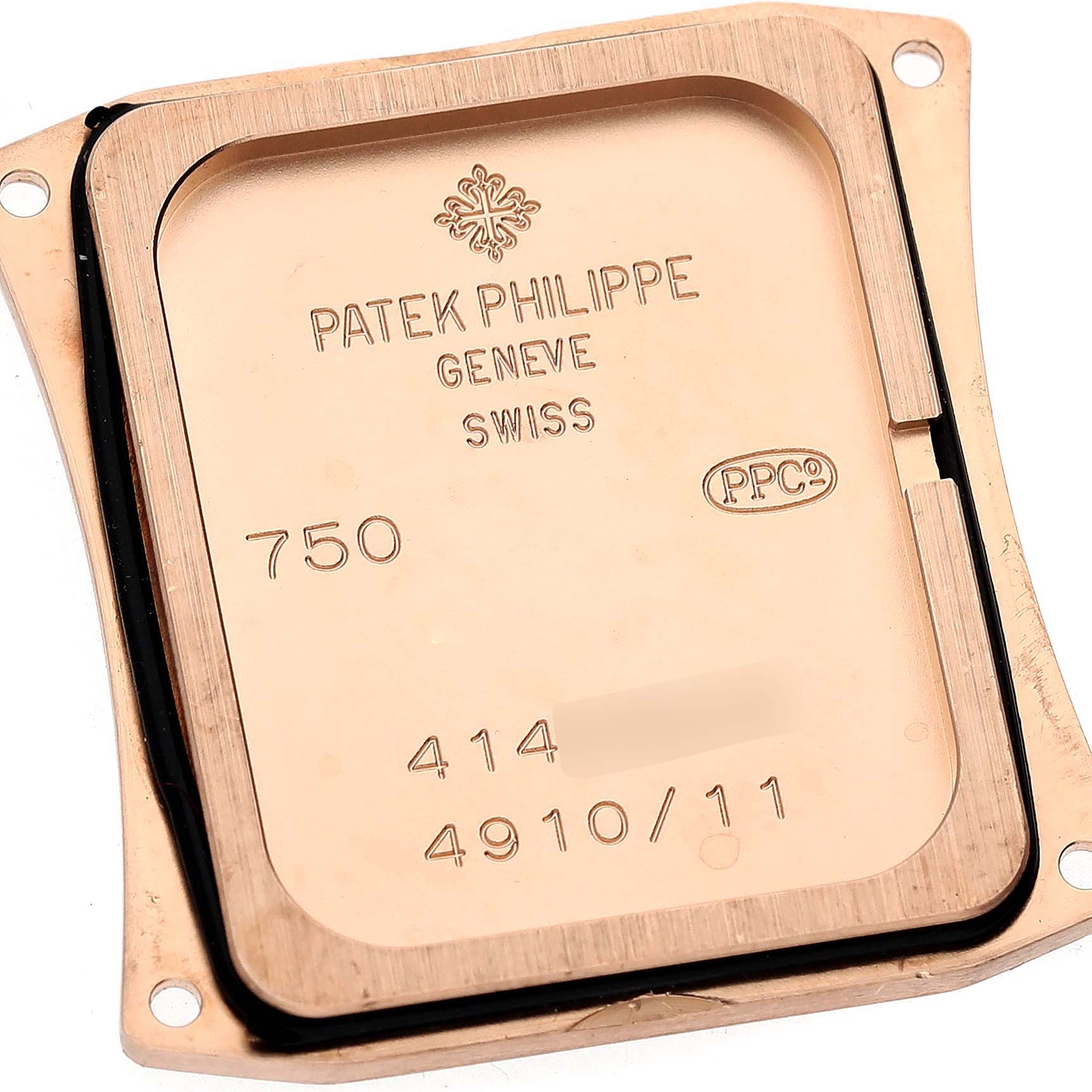 This image shows the back cover of a Patek Philippe Twenty-4 4910/11 Women's Rose Gold Brown Dial 4910/11 Women's Rose Gold Brown Dial watch, displaying its engravings and seal.