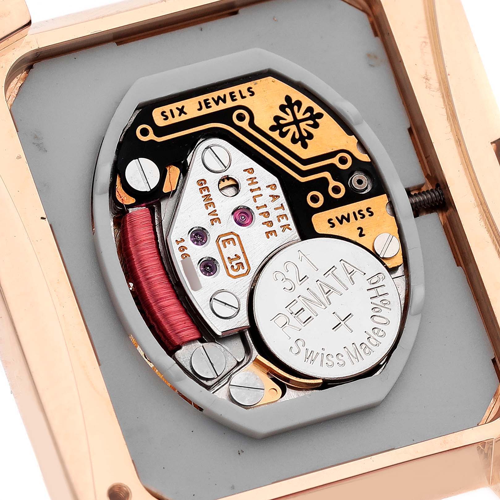 The image shows a close-up of the movement inside a Patek Philippe Twenty-4 4910/11 Women's Rose Gold Brown Dial 4910/11 Women's Rose Gold Brown Dial watch, focusing on its intricate mechanical details.