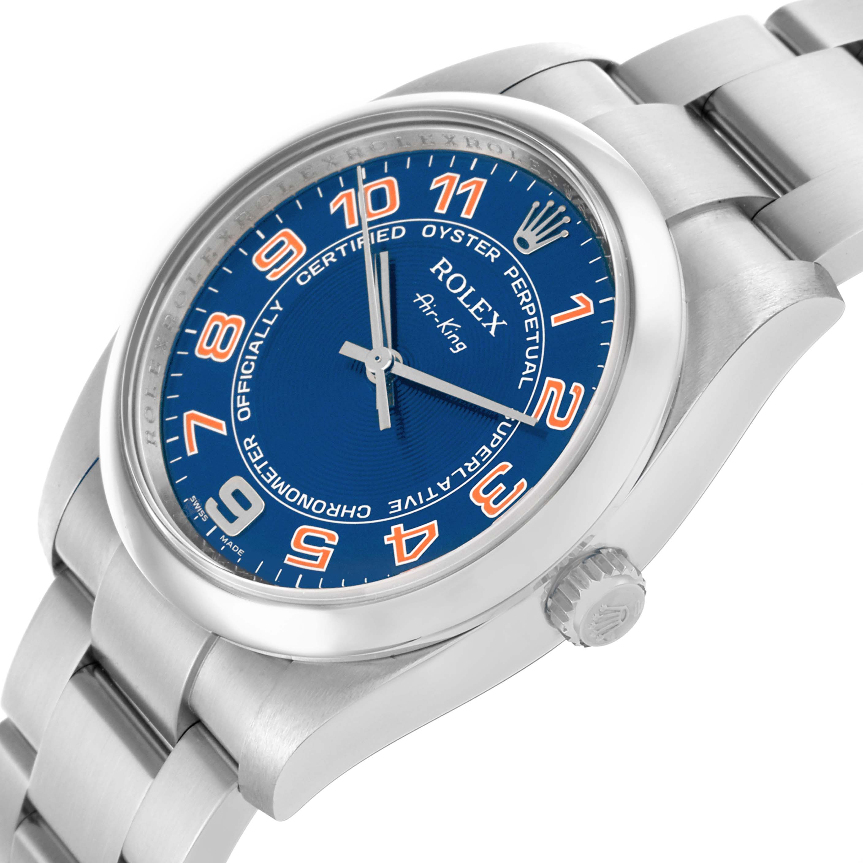 The Rolex Air-King 114200 Men's Stainless Steel Blue Dial 114200 Men's Stainless Steel Blue Dial watch is shown from a three-quarter angle, highlighting the blue dial, orange numbers, and stainless steel bracelet.