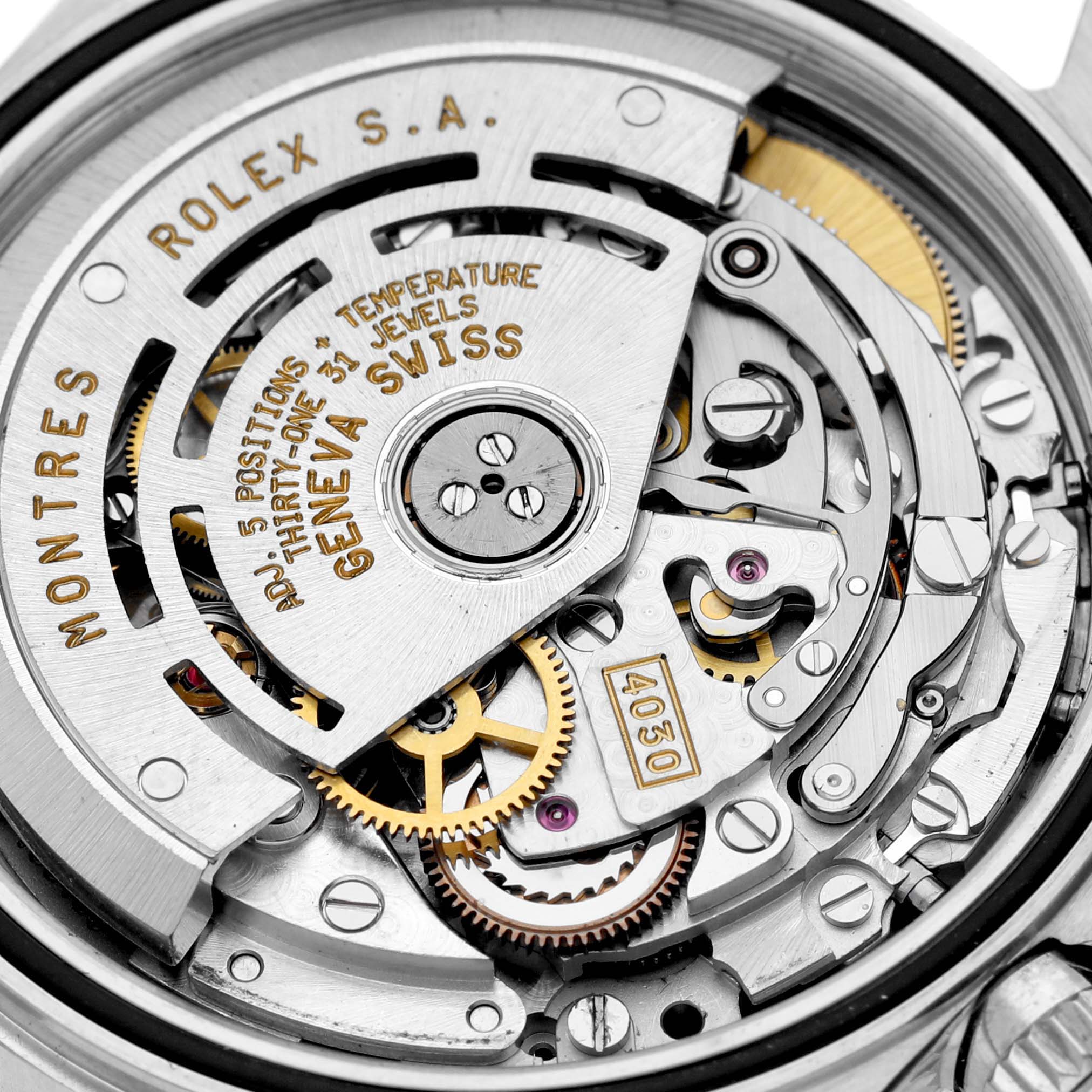 The image shows a close-up view of the Rolex Daytona 16520 Men's Stainless Steel Black Dial 16520 Men's Stainless Steel Black Dial movement, revealing gears and intricate mechanical parts.