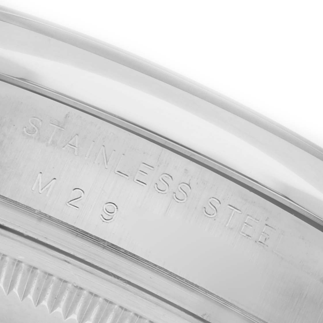 The image shows a close-up of the engraving on the case back edge of a Rolex Date 115200 Men
s Stainless Steel Black Dial 115200 Men
s Stainless Steel Black Dial, highlighting the stainless steel material.