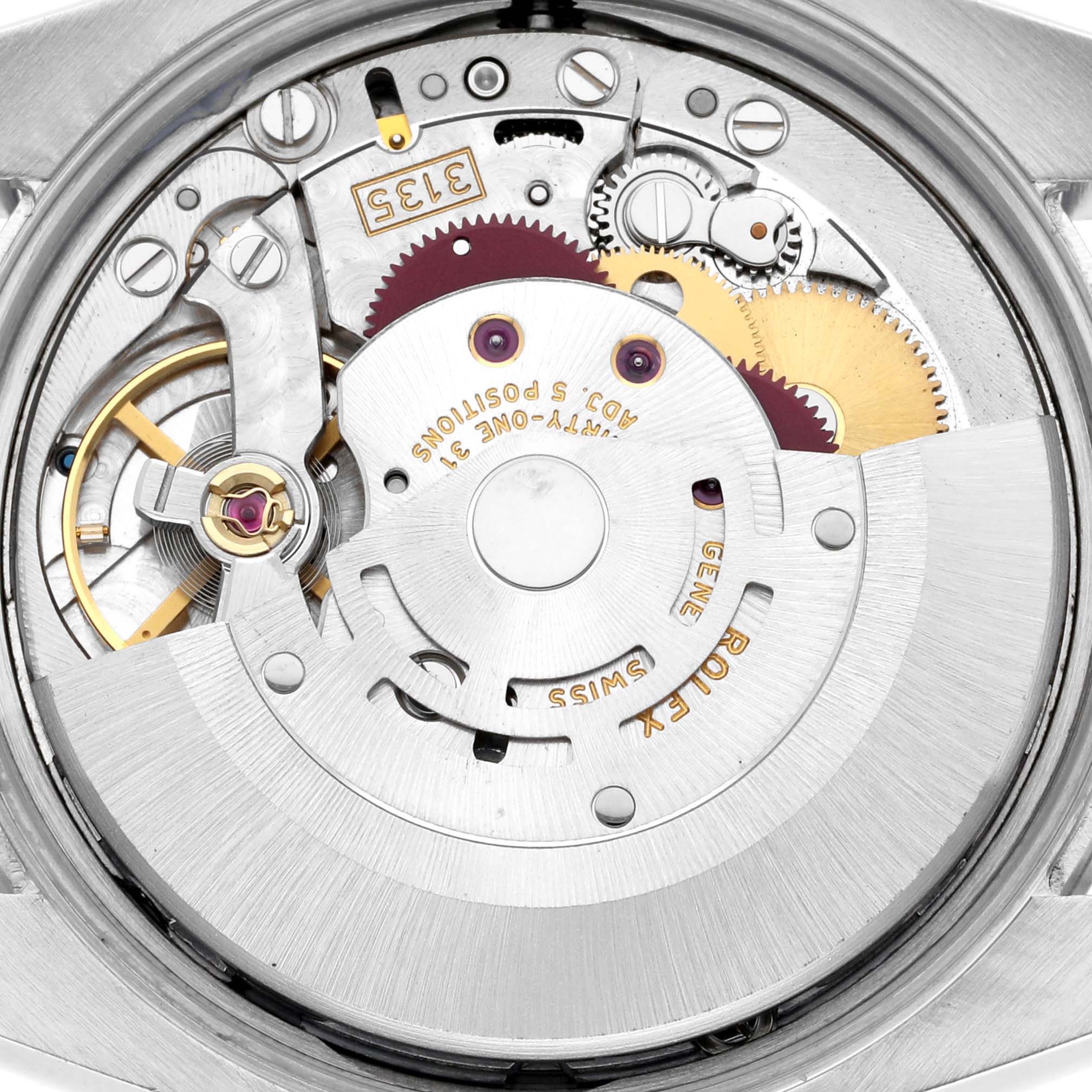 The image shows the movement mechanism of a Rolex Date 115200 Men
s Stainless Steel Black Dial 115200 Men
s Stainless Steel Black Dial watch from a top-down angle, revealing gears and intricate components.
