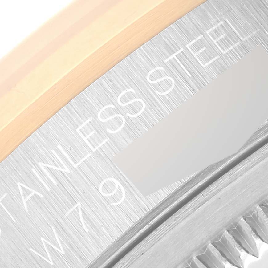 This close-up image shows the engraving on the stainless steel part of the bezel of a Rolex Datejust 16203 Men's Stainless Steel Champagne Dial 16203 Men's Stainless Steel Champagne Dial watch.