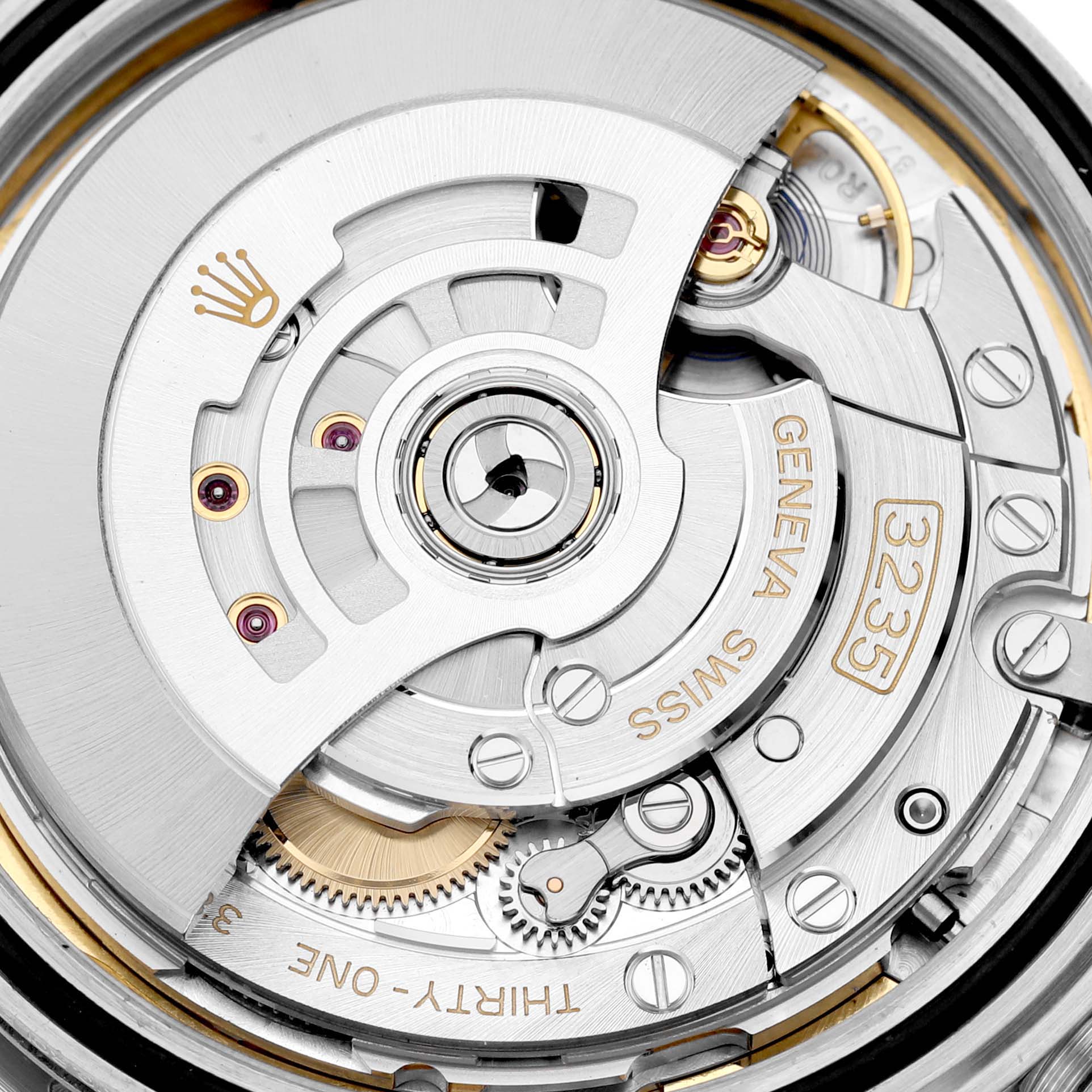 The image shows a close-up of the movement mechanism of a Rolex Datejust 41 126334 Men's Stainless Steel Blue Dial 126334 Men's Stainless Steel Blue Dial, highlighting the intricate gears and rotor.