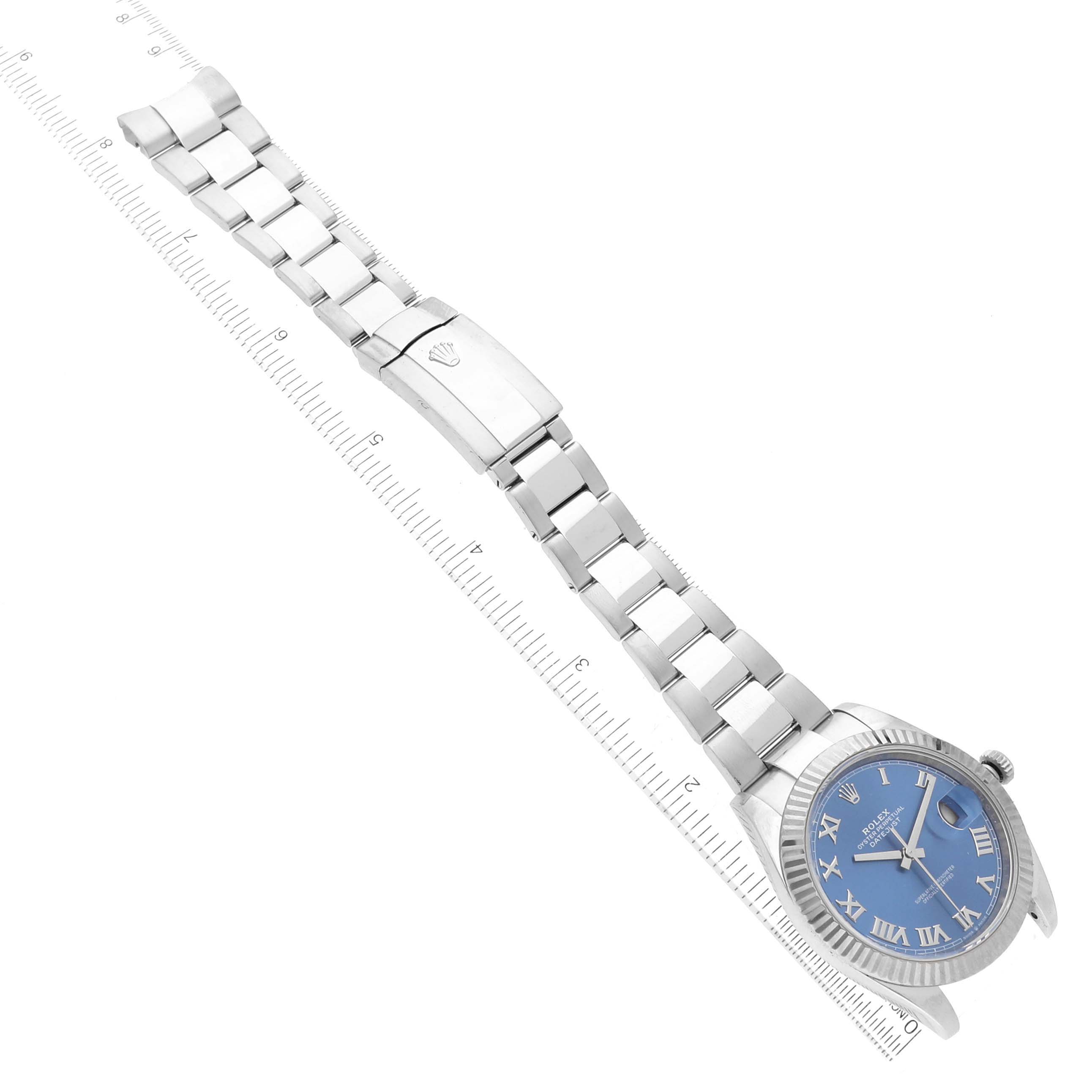 The image shows a top-down view of the Rolex Datejust 41 126334 Men's Stainless Steel Blue Dial 126334 Men's Stainless Steel Blue Dial watch, displaying its blue Roman numeral dial and metal bracelet with clasp.