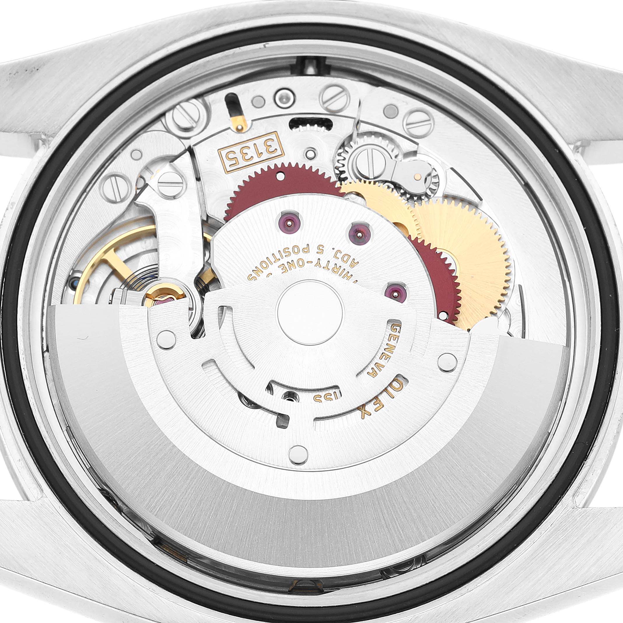 The image shows the back view of a Rolex Datejust 116200 Men's Stainless Steel Blue Dial, exposing its intricate mechanical movement and components.