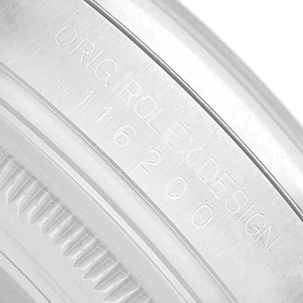 The image shows a close-up of the engraving on the inner bezel of a Rolex Datejust 116200 Men's Stainless Steel Blue Dial watch.