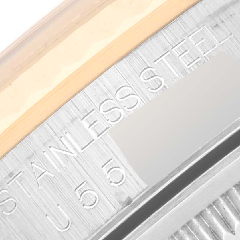 This close-up image shows the edge of the bezel and part of the case back of a Rolex Datejust 16233 Men's Steel and Gold (two tone) Blue Dial 16233 Men's Steel and Gold (two tone) Blue Dial watch, highlighting the "STAINLESS STEEL" engraving.