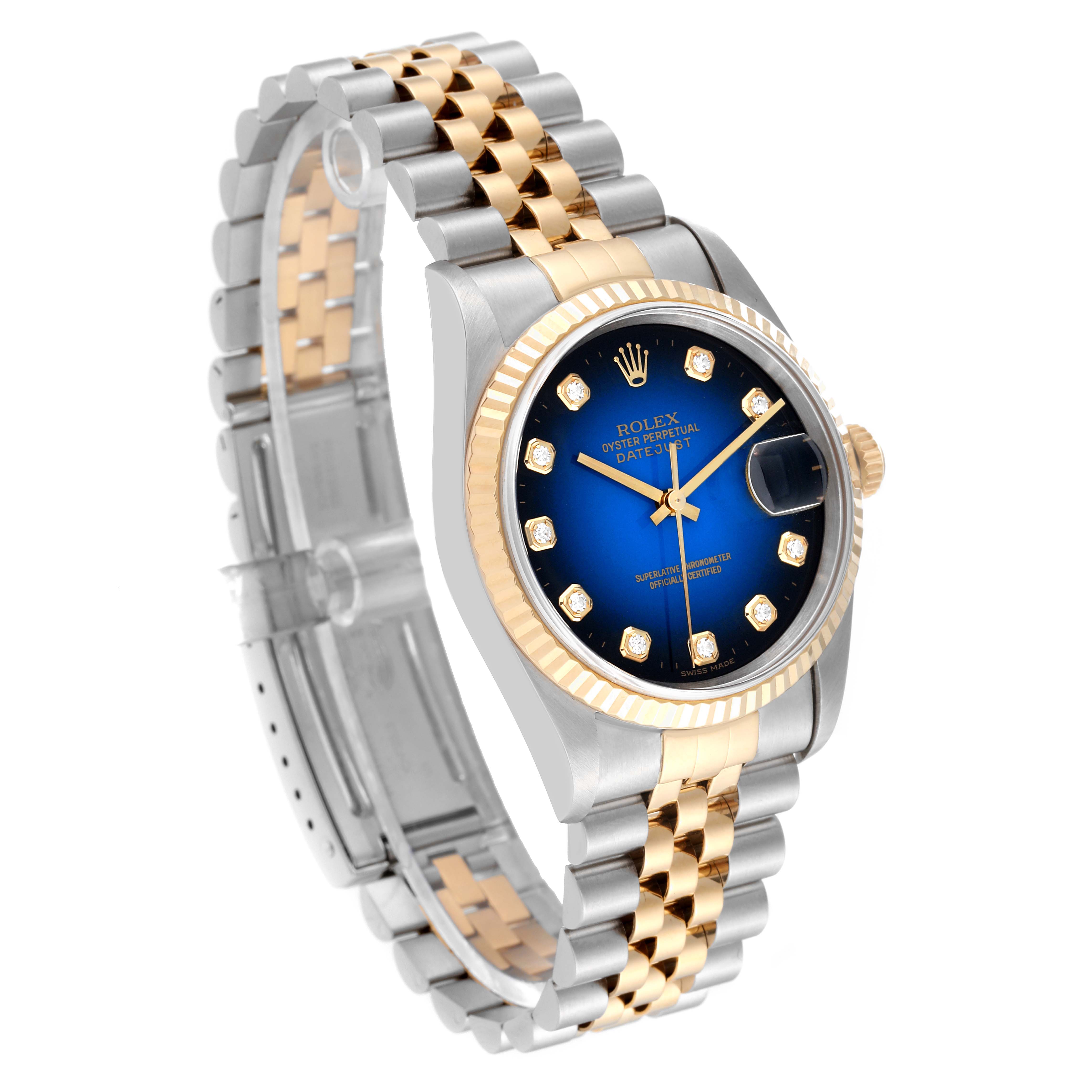 This Rolex Datejust 16233 Men's Steel and Gold (two tone) Blue Dial 16233 Men's Steel and Gold (two tone) Blue Dial watch is shown at a 3/4 angle, displaying the blue dial, fluted bezel, and two-tone bracelet.