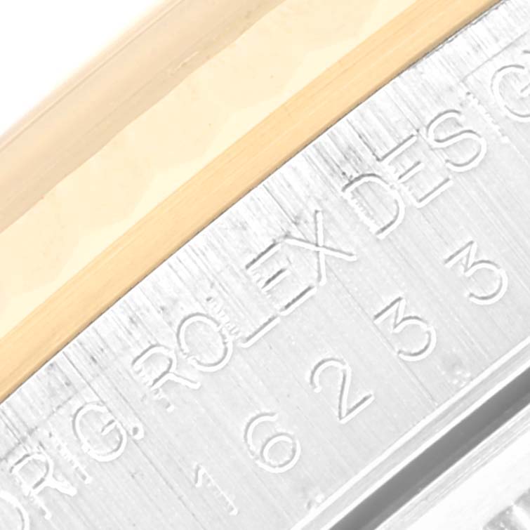 The image shows a close-up of the engraved bezel of a Rolex Datejust 16233 Men's Steel and Gold (two tone) Blue Dial 16233 Men's Steel and Gold (two tone) Blue Dial watch.