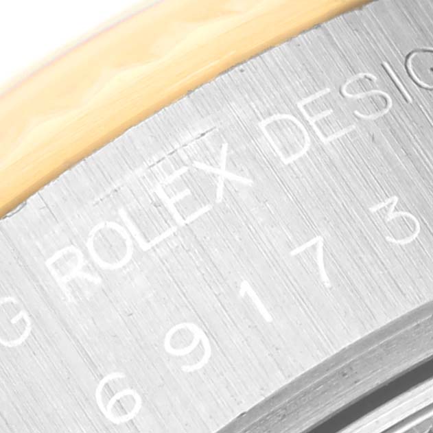 This image shows a close-up of the engraved serial number and "Rolex Design" wording on a Rolex Datejust 69173G Women's Steel and Gold (two tone) Champagne Dial 69173G Women's Steel and Gold (two tone) Champagne Dial model.