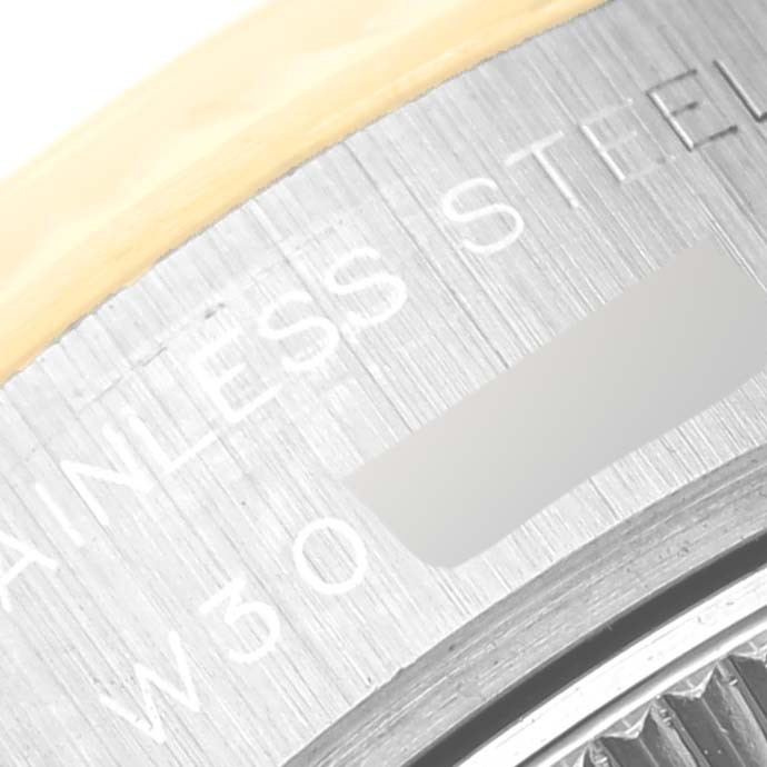 The image shows a close-up of the stainless steel rim with engravings on a Rolex Datejust 69173G Women's Steel and Gold (two tone) Champagne Dial 69173G Women's Steel and Gold (two tone) Champagne Dial watch case.