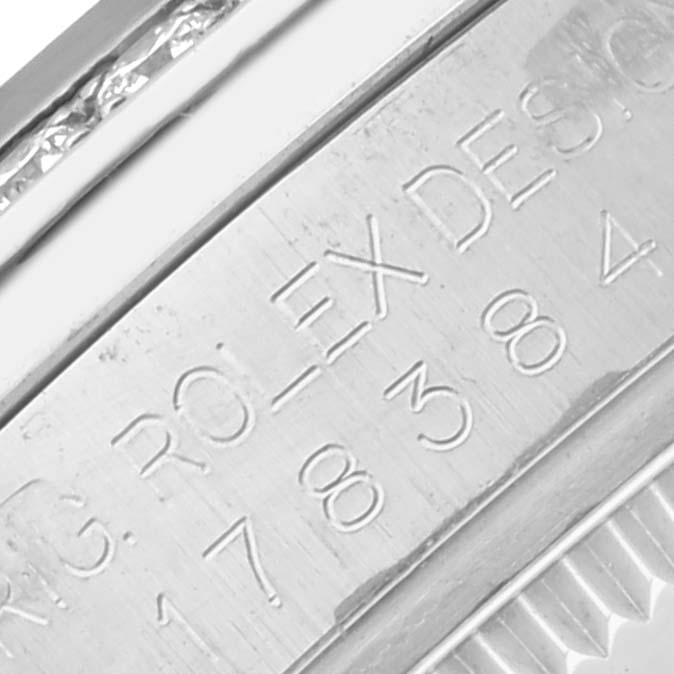 The image shows a close-up of the engraved side of a Rolex Mid-Size 178384 Women's Stainless Steel Mother of Pearl Dial 178384 Women's Stainless Steel Mother of Pearl Dial watch, highlighting serial or model details.