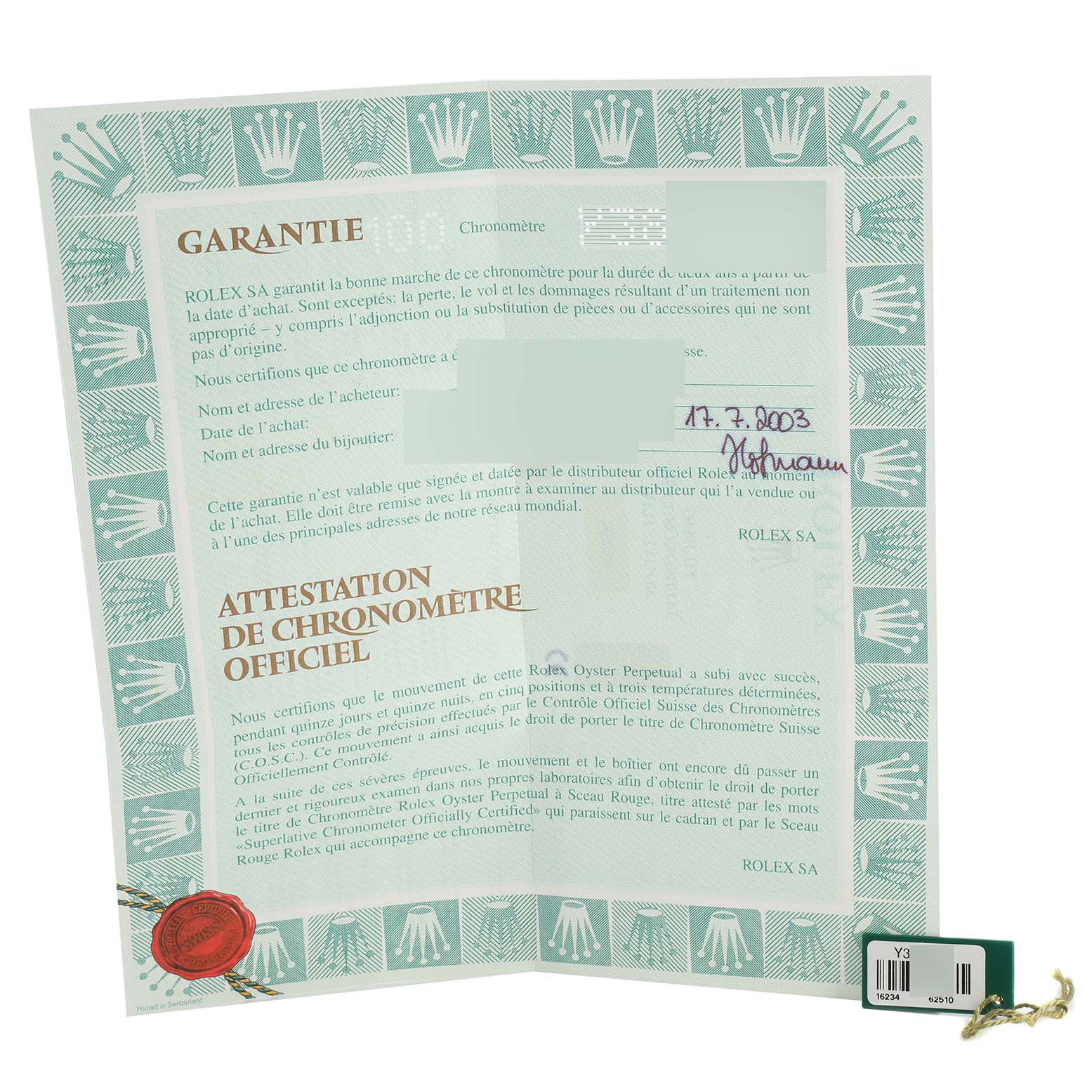 The image shows a Rolex Datejust 16234 Men's Stainless Steel White Dial 16234 Men's Stainless Steel White Dial warranty certificate and a green tag, viewed from above.