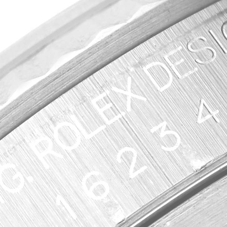 This close-up image shows the engraved inner bezel of a Rolex Datejust 16234 Men's Stainless Steel White Dial 16234 Men's Stainless Steel White Dial.