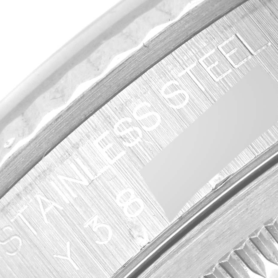 This close-up image shows the inscription detailing and part of the bezel of a Rolex Datejust 16234 Men's Stainless Steel White Dial 16234 Men's Stainless Steel White Dial watch.