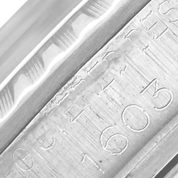 The image shows a close-up of the engraved inner bezel of a Rolex Datejust 1603 Men
s Stainless Steel Silver Dial 1603 Men
s Stainless Steel Silver Dial watch.