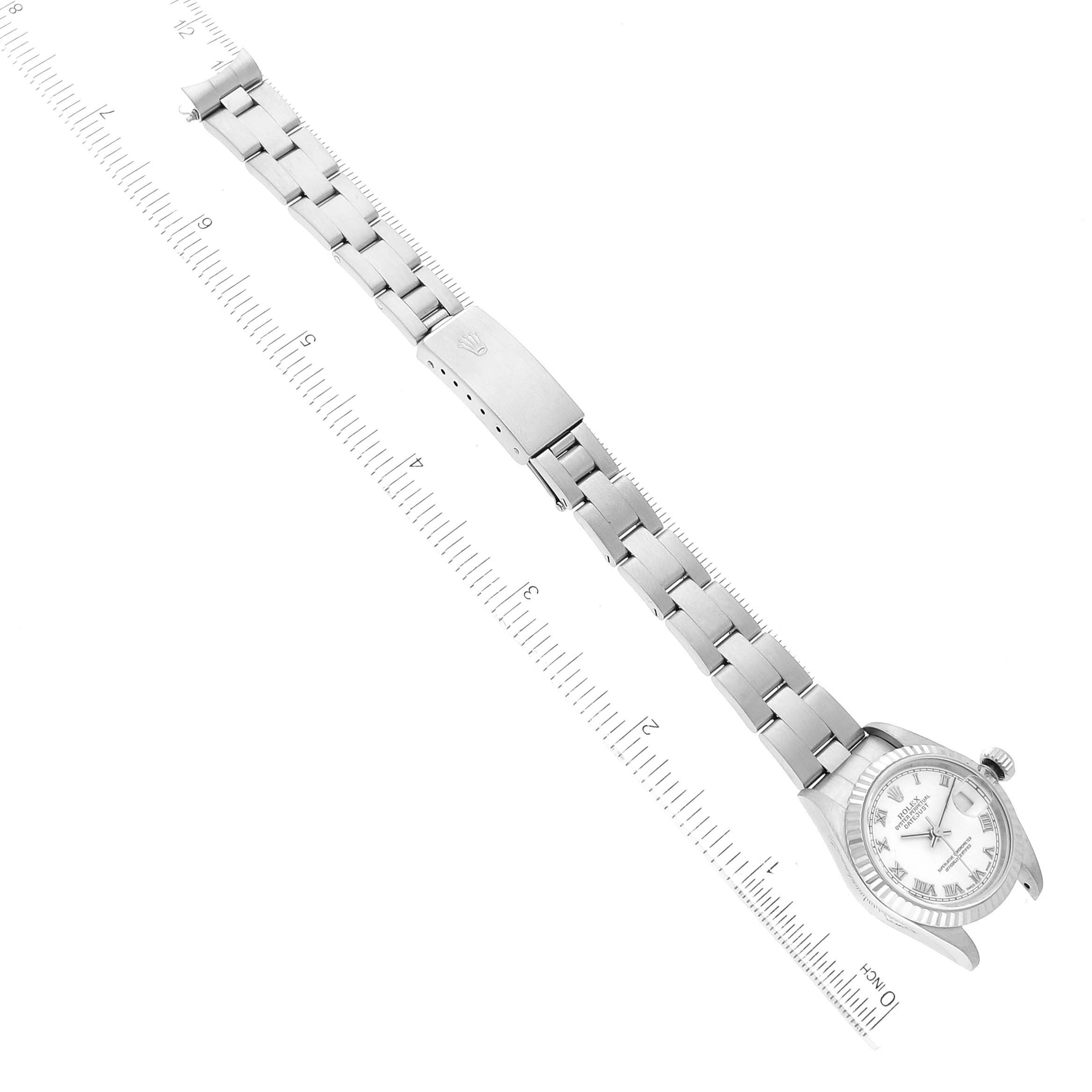 The image shows a top-down view of a Rolex Datejust 79174 Women's Stainless Steel White Dial 79174 Women's Stainless Steel White Dial watch with a ruler beside it to indicate measurements.