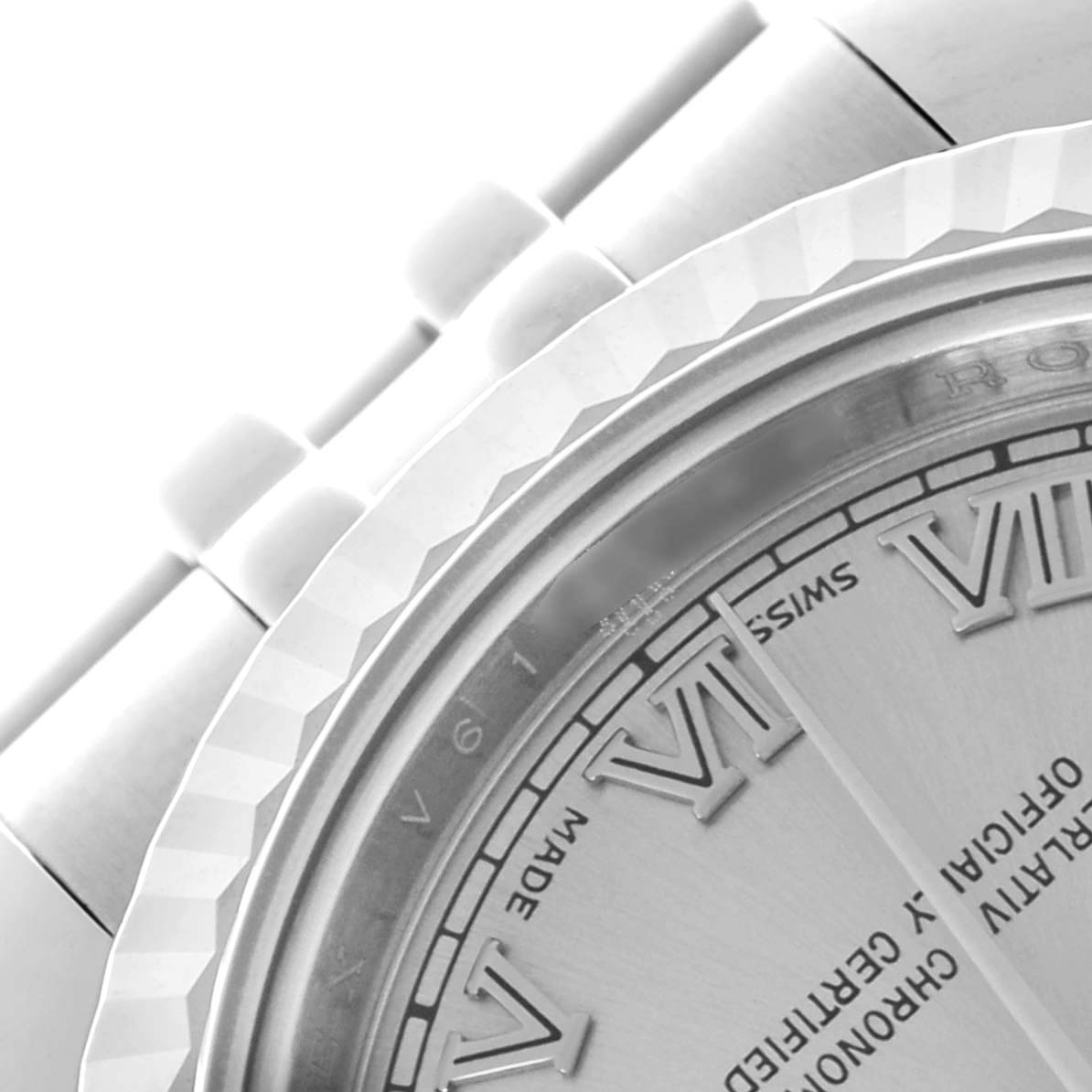 The image shows a close-up of the Rolex Datejust 179174 Women's Stainless Steel Silver Dial 179174 Women's Stainless Steel Silver Dial's bezel, part of the face, and bracelet links from an angled perspective.