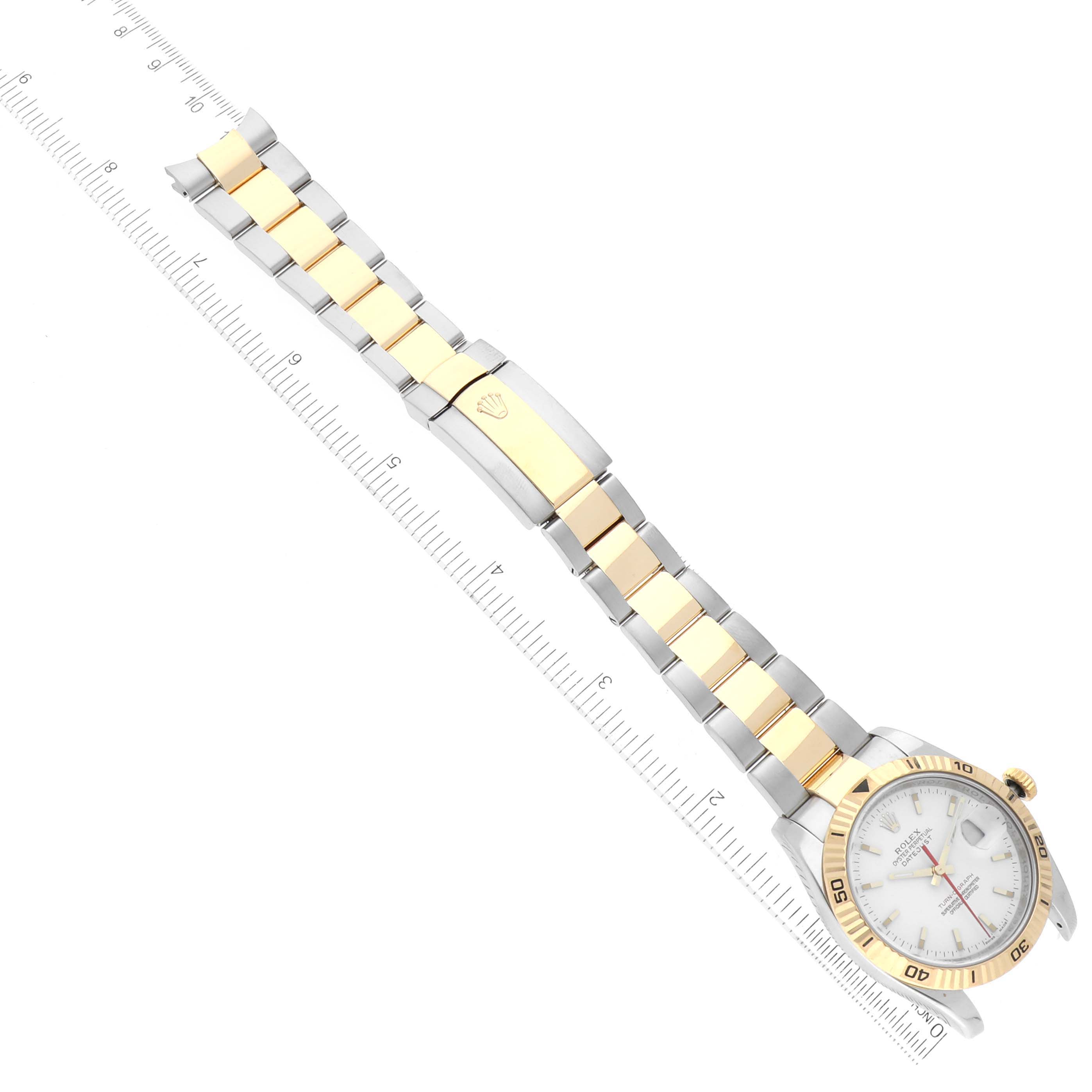 The image shows a Rolex Turn-o-Graph 116263 Men
s Steel and Gold (two tone) White Dial 116263 Men
s Steel and Gold (two tone) White Dial watch laid flat with a clear view of the face, bezel, bracelet, and clasp, alongside a ruler.