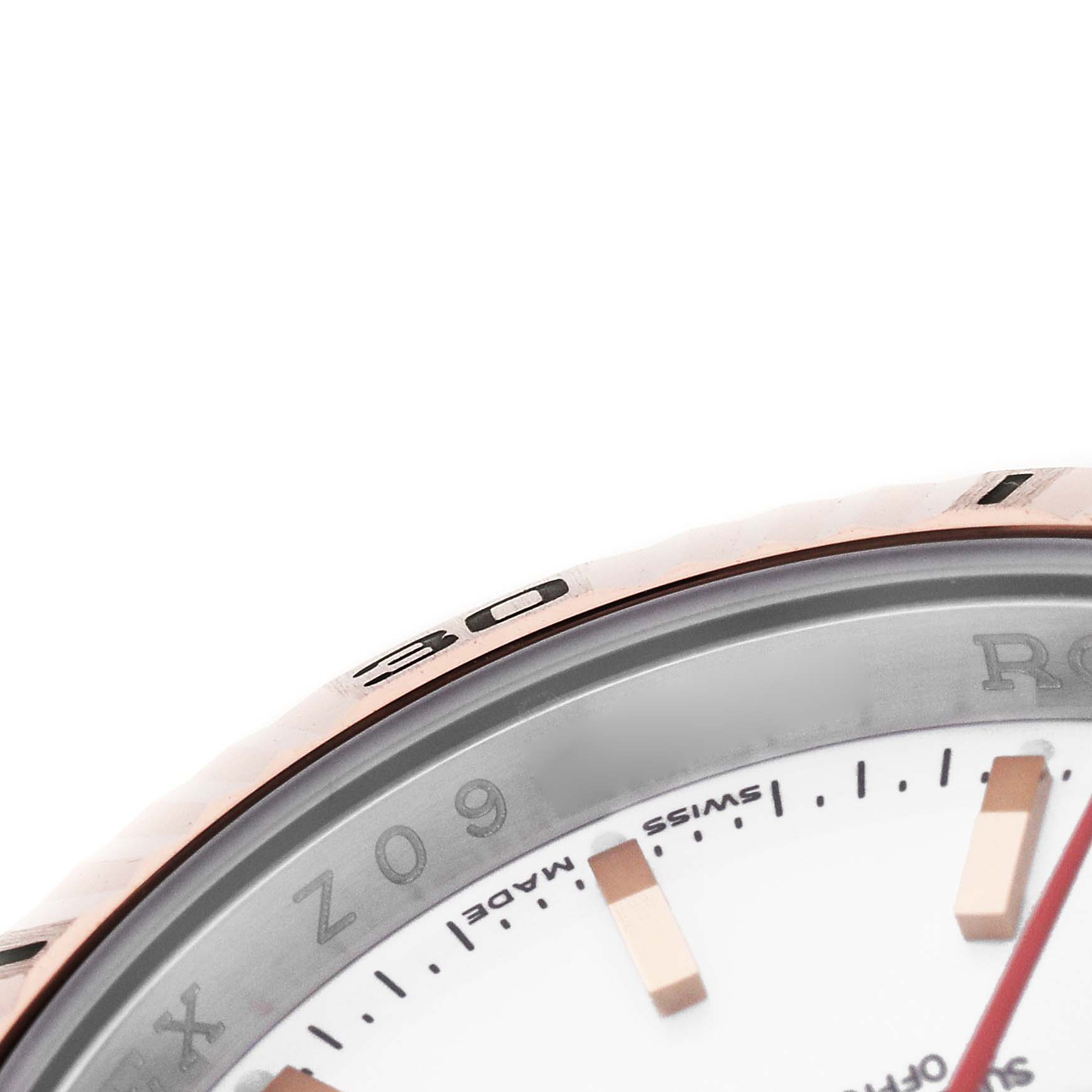 The image shows a close-up of the bezel and part of the dial of a Rolex Turn-o-Graph 116261 Men's Steel and Gold (two tone) White Dial watch, highlighting the minute markers and text.