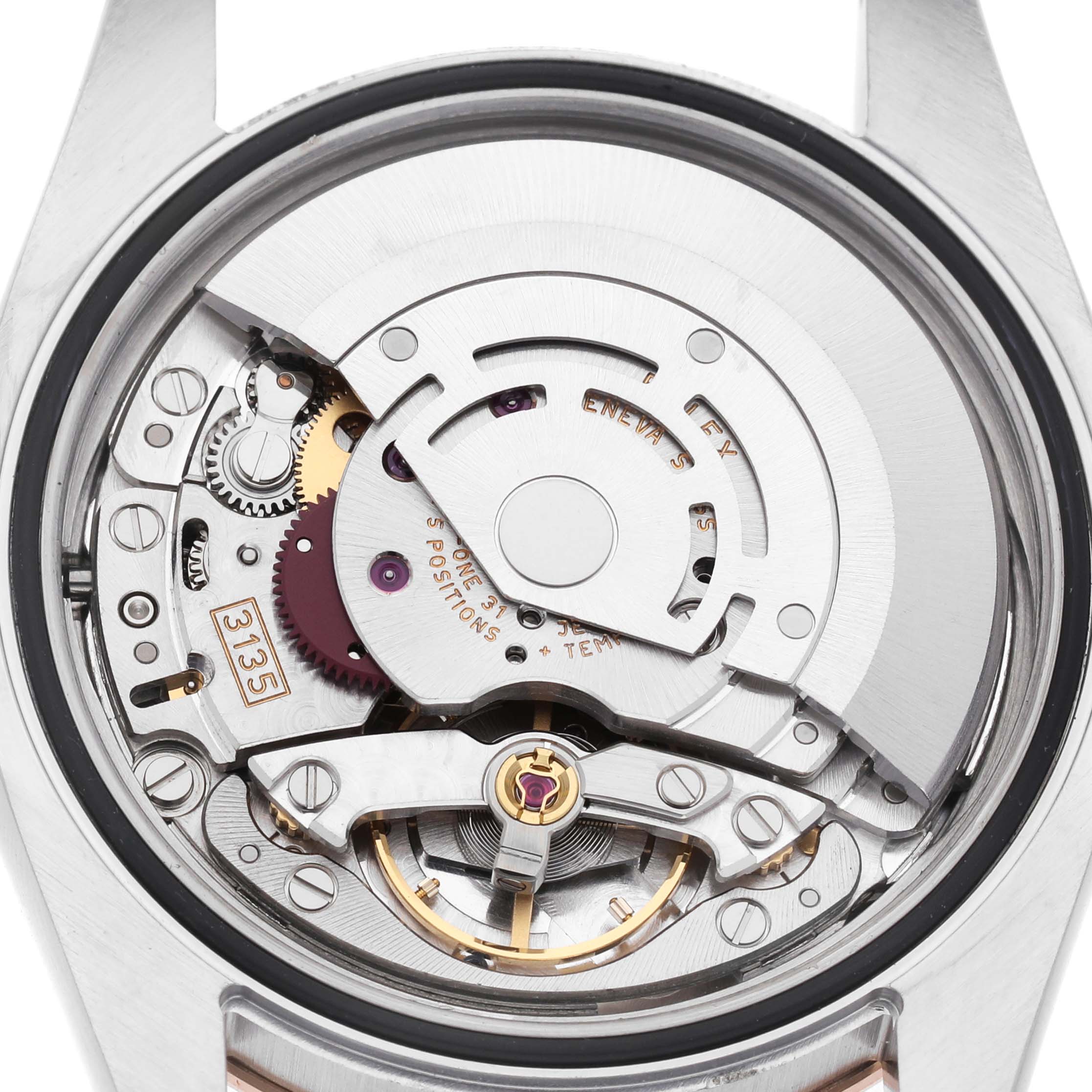 This image shows the movement of a Rolex Turn-o-Graph 116261 Men's Steel and Gold (two tone) White Dial, highlighting gears and mechanical components from the back.