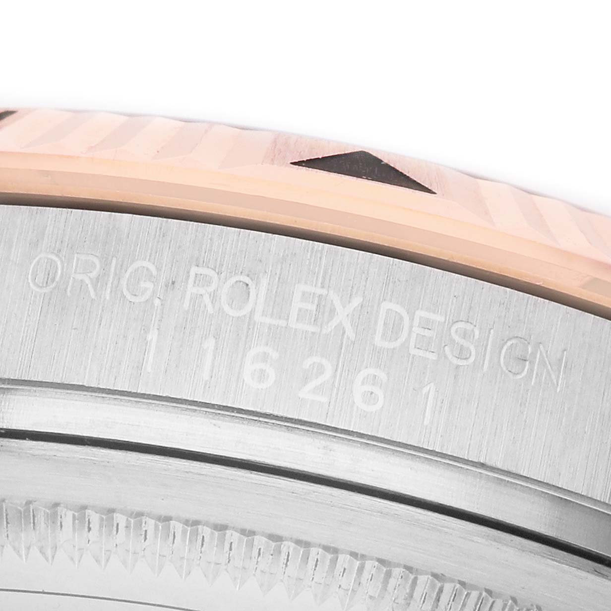 The image shows a close-up of the Rolex Turn-o-Graph 116261 Men's Steel and Gold (two tone) White Dial bezel and engraved case edge, viewed from the side.
