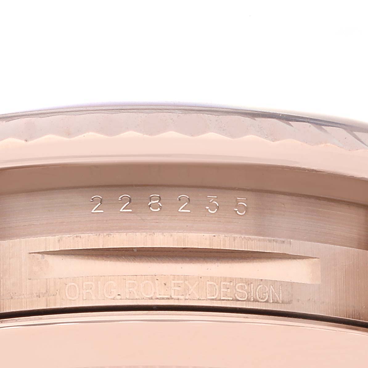 This image shows a close-up of the serial and model number on the case of a Rolex President 228235 Men's Rose Gold Brown Dial 228235 Men's Rose Gold Brown Dial watch.