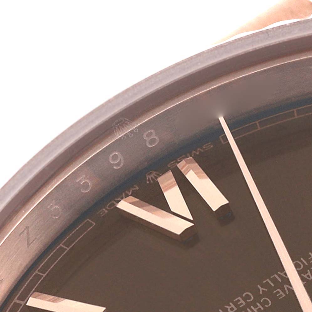 This close-up angle of the Rolex President 228235 Men's Rose Gold Brown Dial 228235 Men's Rose Gold Brown Dial model shows the edge of the dial, numeral markers, and part of the minute hand.