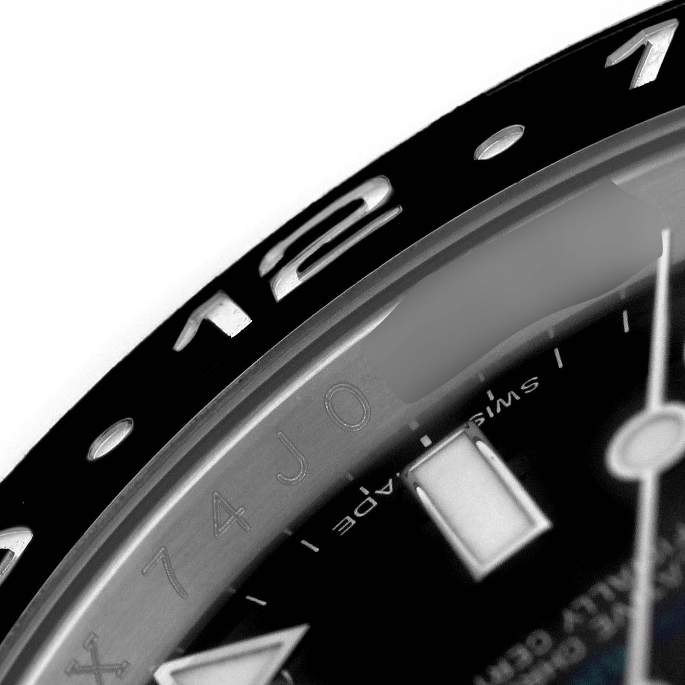 The image shows a close-up of the bezel and part of the dial of a Rolex GMT-Master 116710LN Men's Stainless Steel Black Dial watch.