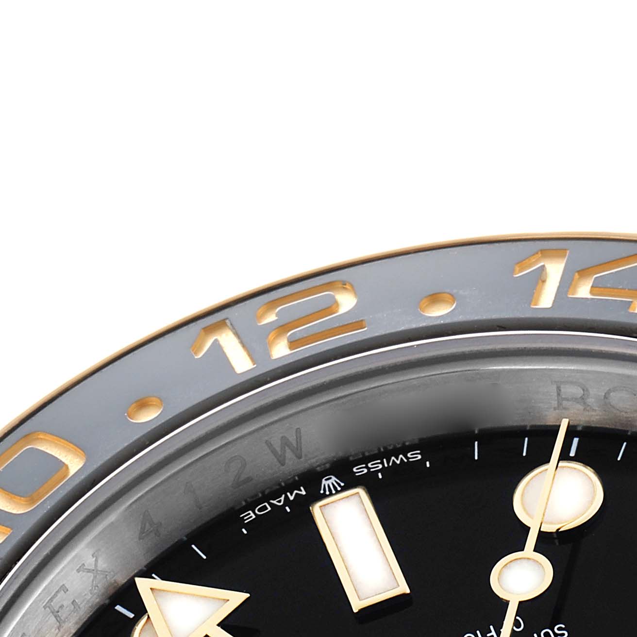 The image shows a close-up of the bezel and part of the dial of a Rolex GMT-Master 126713 Men's Steel and Gold (two tone) Black Dial watch, highlighting the numerals and part of the hands.
