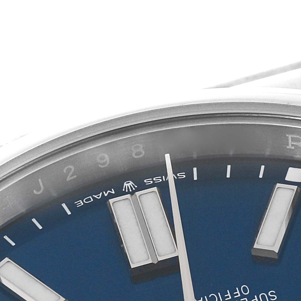 This is a close-up image of the Rolex Oyster Perpetual 124300 Men
s Stainless Steel Blue Dial 124300 Men
s Stainless Steel Blue Dial watch, showing part of the blue dial, indices, and the "Swiss Made" branding.