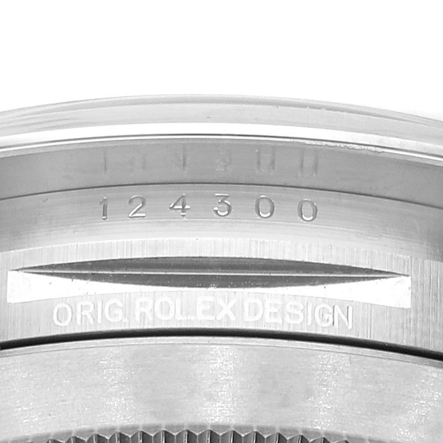 The image shows the inner bezel and part of the case back of an Oyster Perpetual model by Rolex, featuring the reference number 124300.