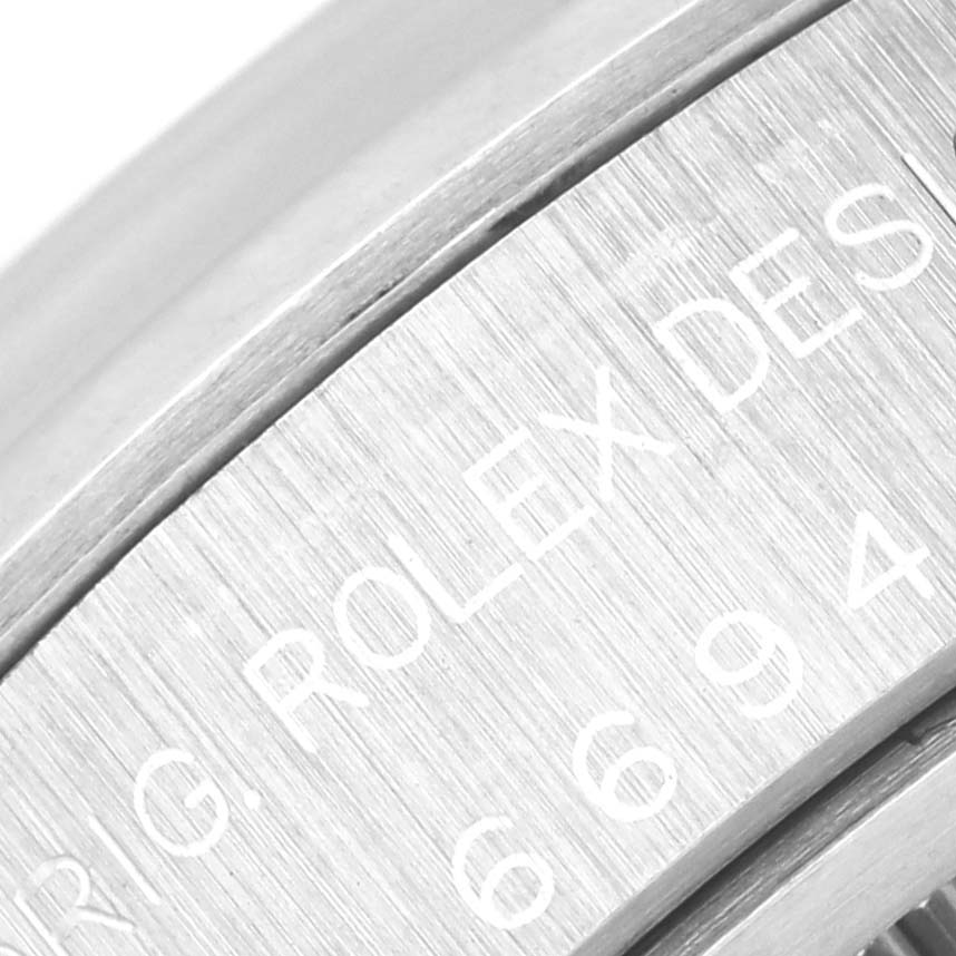 Close-up of the side engraving of a Vintage Collection Rolex watch, showing part of the serial and design numbers.