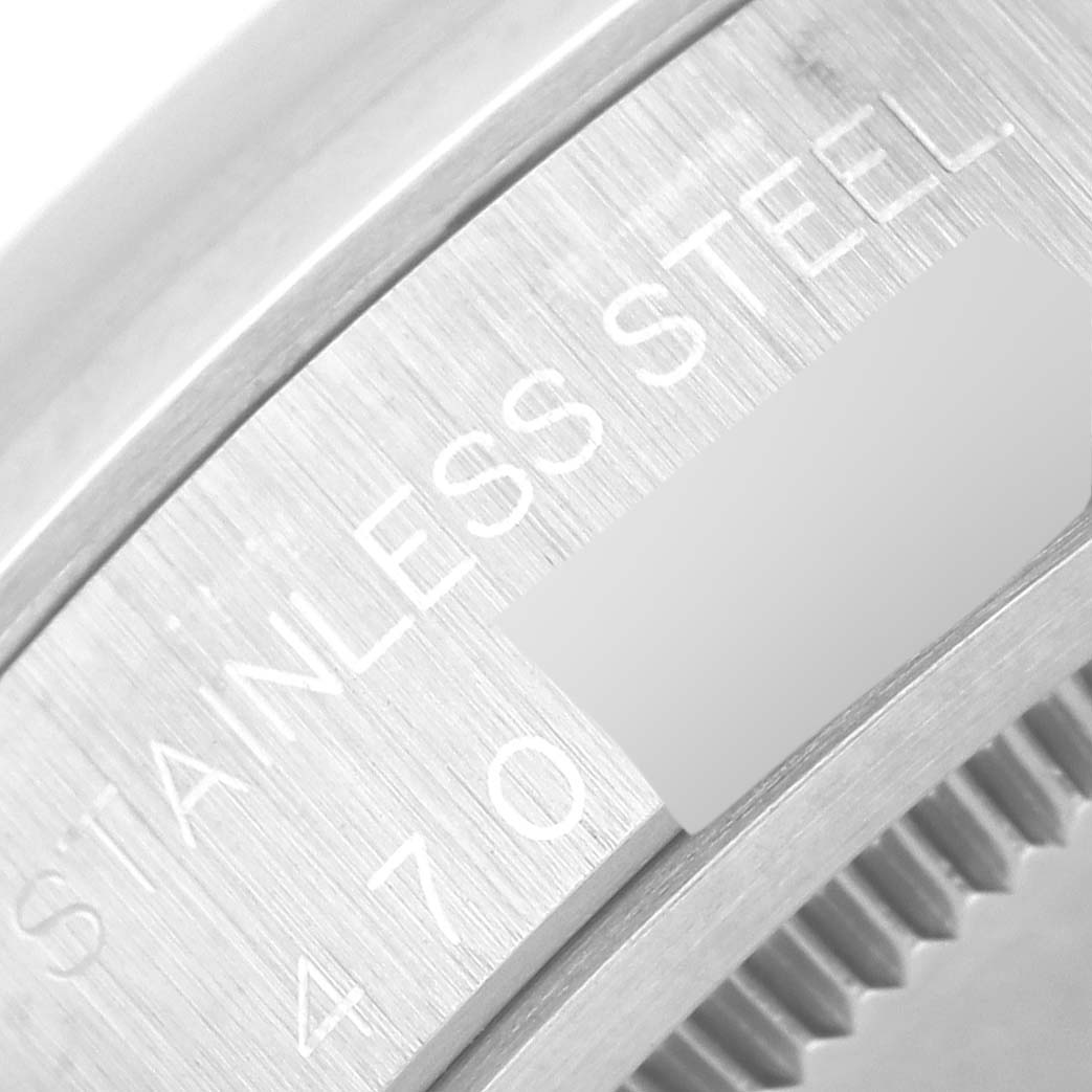 This close-up image shows the edge and engraved details of the Rolex Vintage Collection 6694 Men's Stainless Steel Silver Dial 6694 Men's Stainless Steel Silver Dial watch, focusing on the stainless steel inscription.