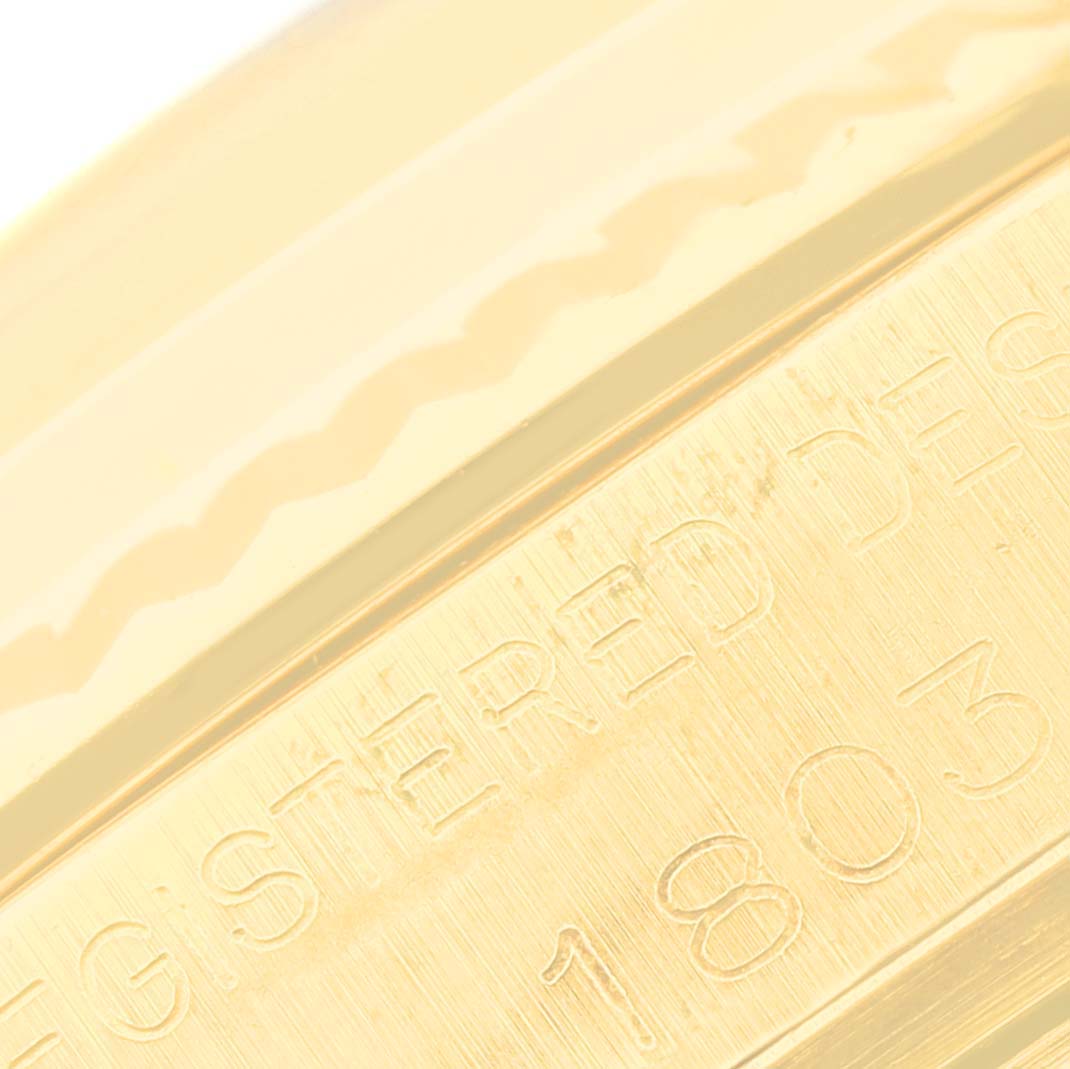 This close-up image shows the engraved text and edge detail on the case of the Rolex Vintage Collection 1803 Men's Yellow Gold Champagne Dial 1803 Men's Yellow Gold Champagne Dial model.