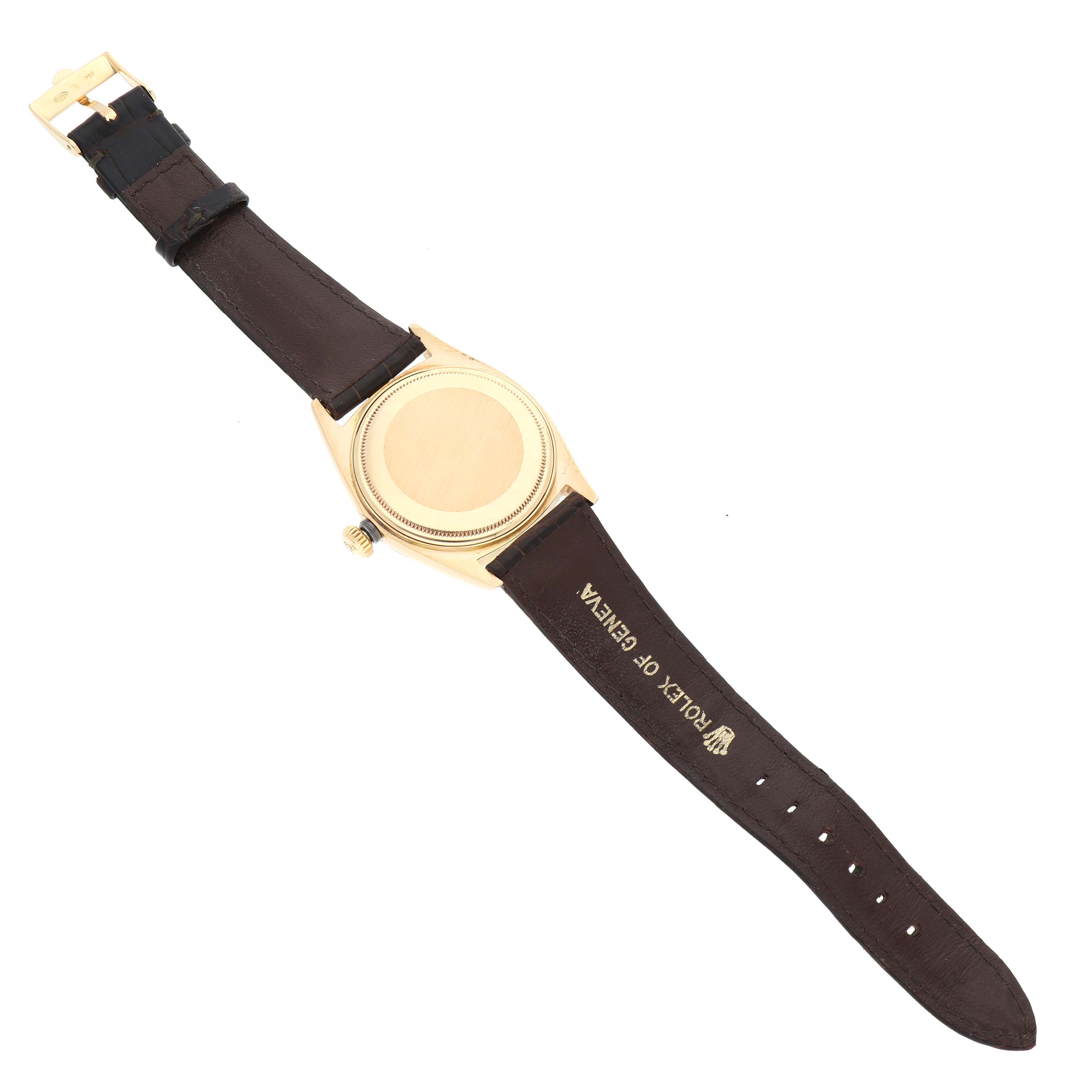 The Rolex Vintage Collection 1803 Men's Yellow Gold Champagne Dial 1803 Men's Yellow Gold Champagne Dial watch is shown from the back, including the case back, leather strap, buckle, and crown.