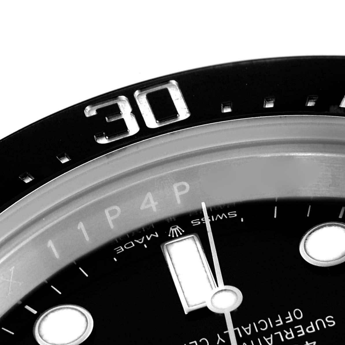 The image shows a close-up of the bezel and dial of a Rolex Sea-Dweller 126600 Men's Stainless Steel Black Dial, highlighting the 30-minute mark and a portion of the indices.