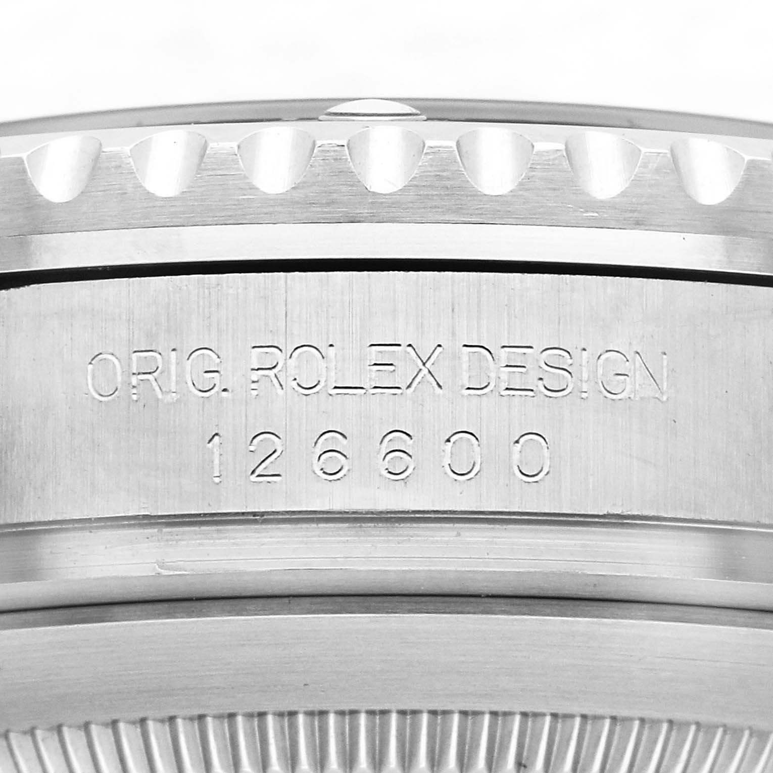 The image shows a close-up of the side casing of the Rolex Sea-Dweller 126600 Men's Stainless Steel Black Dial, featuring the model number and design engraving.