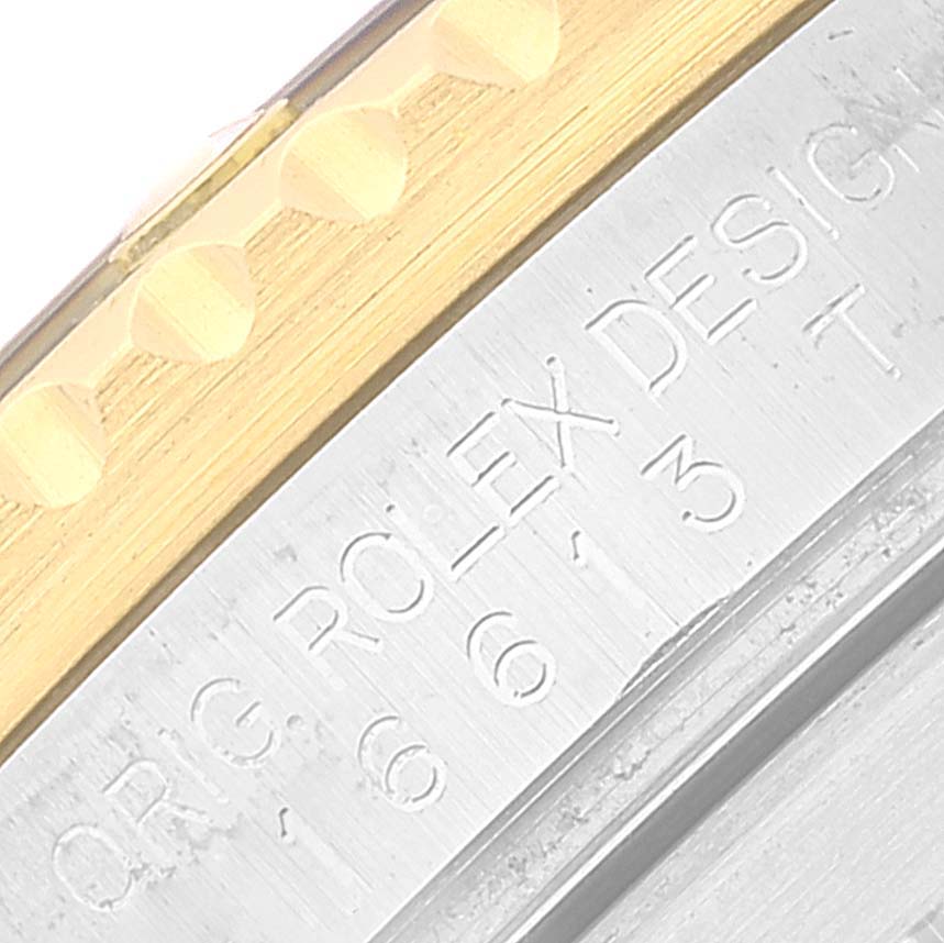 This close-up image shows the bezel and part of the case with engraved details of the Rolex Submariner 16613 Men's Steel and Gold (two tone) Blue Dial 16613 Men's Steel and Gold (two tone) Blue Dial watch.