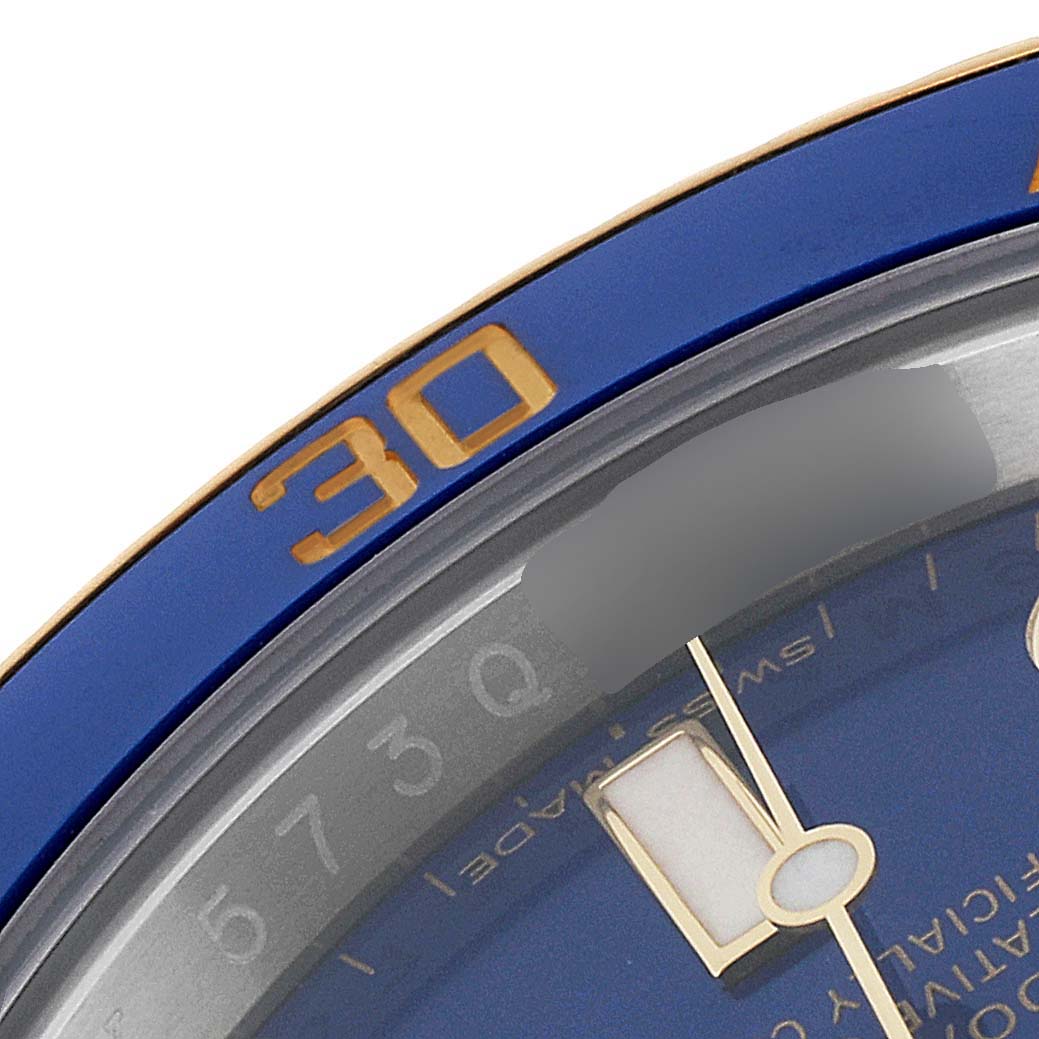 This close-up image shows the bezel and part of the dial and hour hand of the Rolex Submariner 116613 Men's Steel and Gold (two tone) Blue Dial 116613 Men's Steel and Gold (two tone) Blue Dial watch.