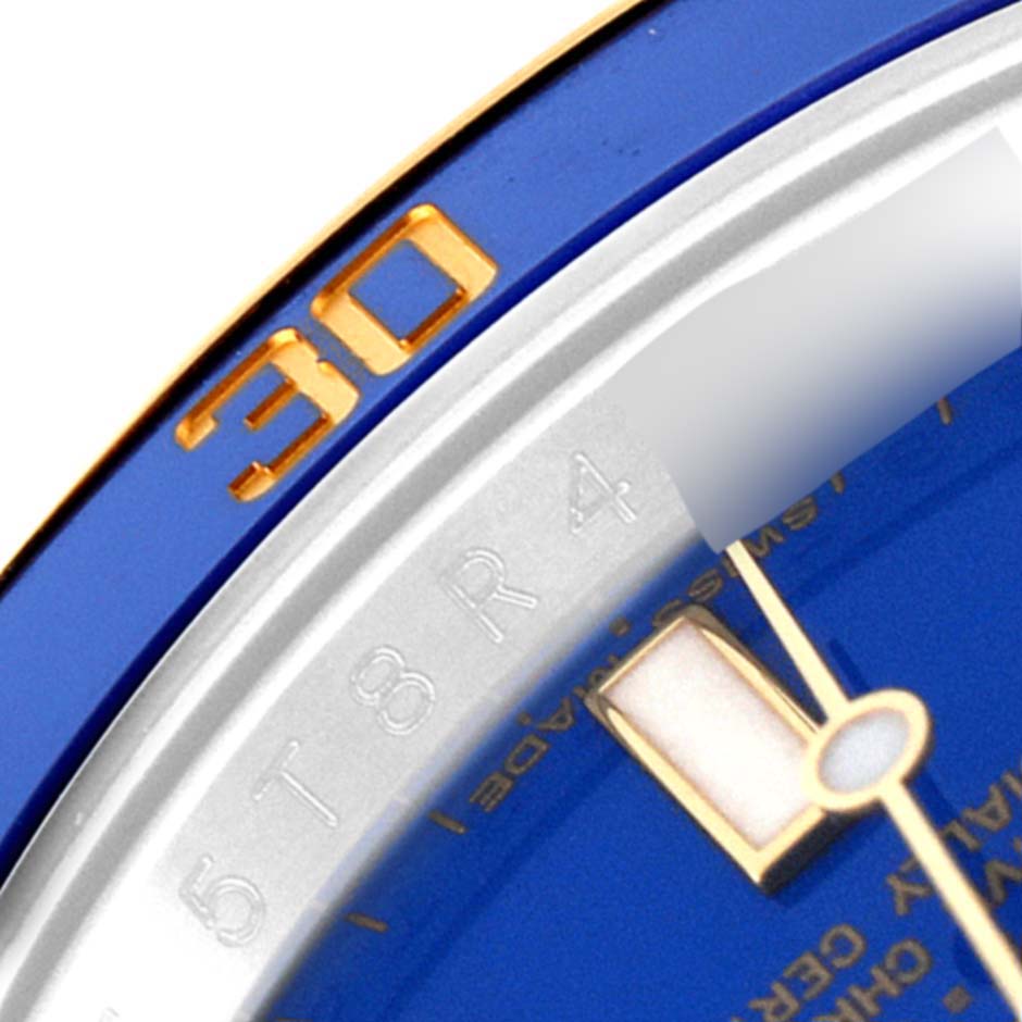 This is a close-up angle showing the bezel and part of the dial for a Rolex Submariner 116613 Men's Steel and Gold (two tone) Blue Dial 116613 Men's Steel and Gold (two tone) Blue Dial model.
