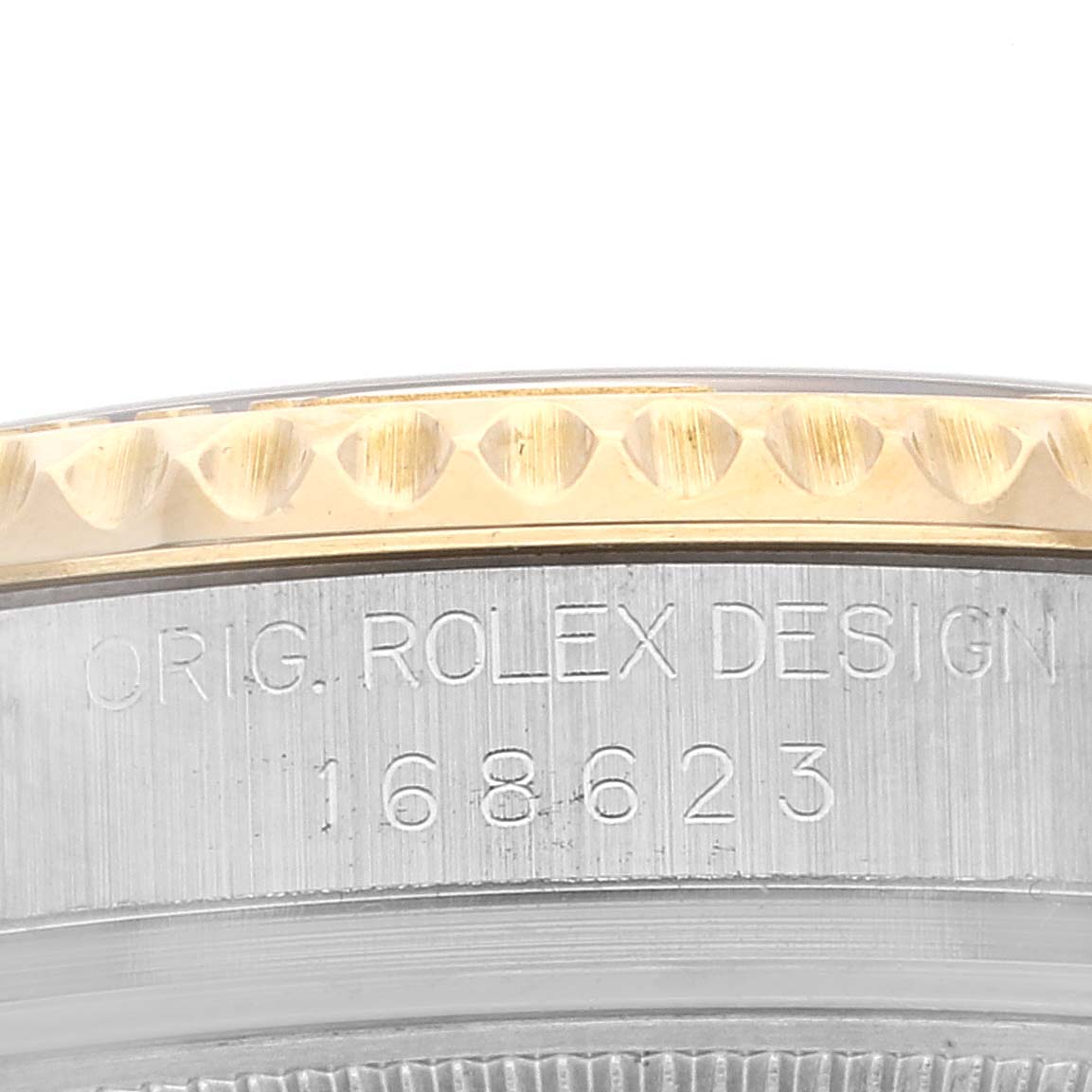 The image shows a close-up of the side of a Rolex Yacht-Master 168623 Men
s Steel and Gold (two tone) White Dial 168623 Men
s Steel and Gold (two tone) White Dial watch, highlighting the model number and original Rolex design engraving.
