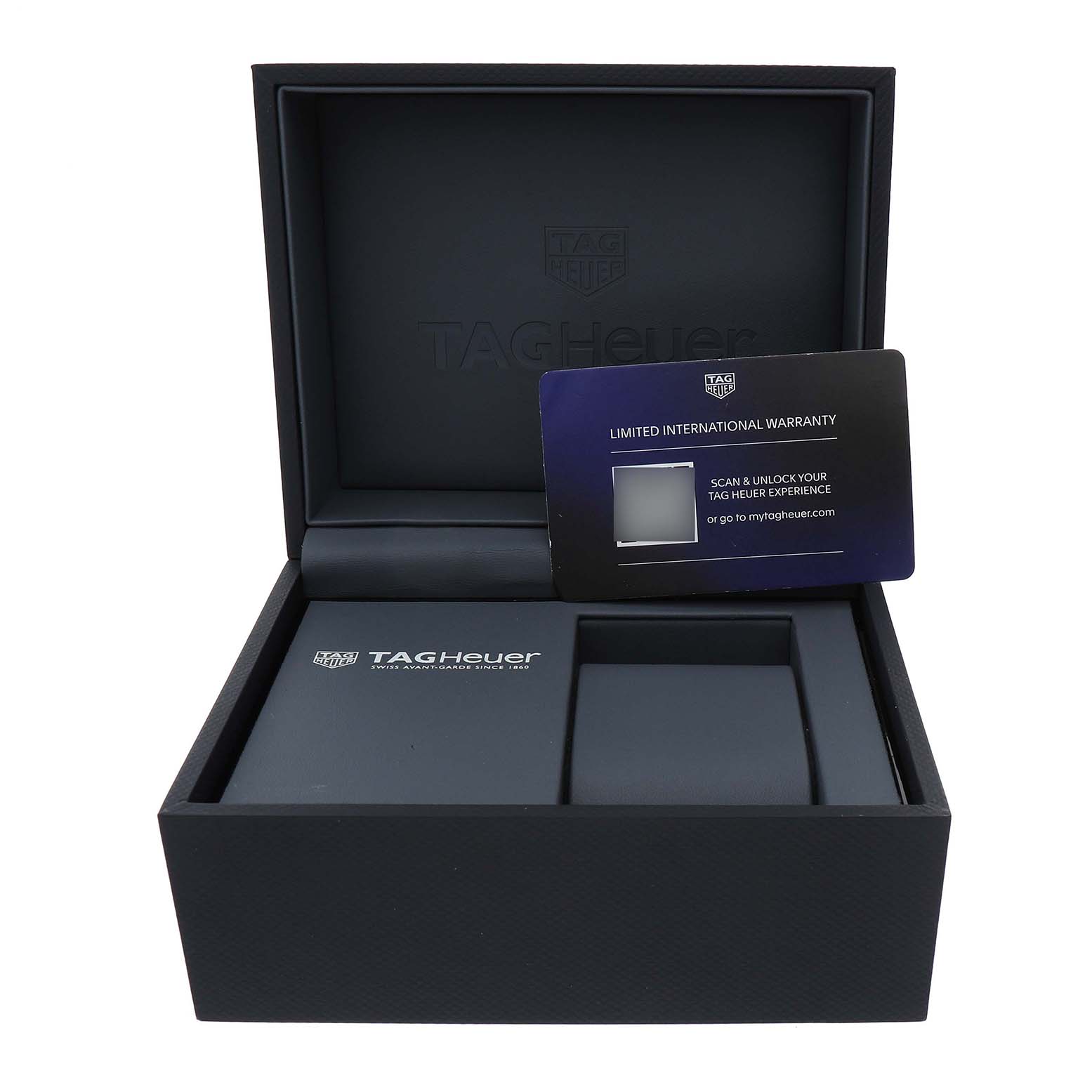 The image shows an open TAG Heuer Carrera watch box at an angle, revealing the interior and warranty card.