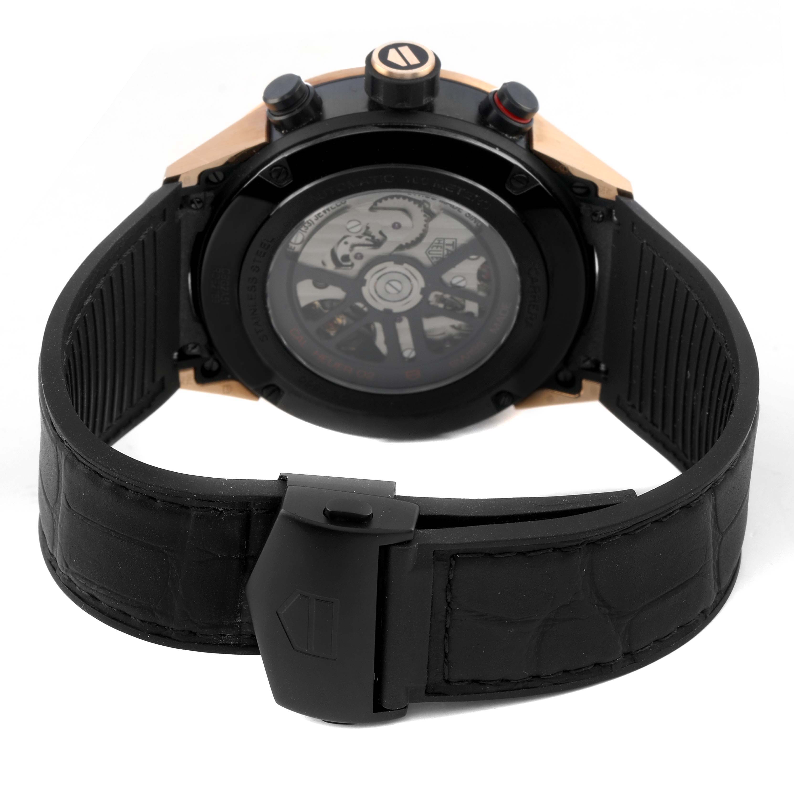 The Tag Heuer Carrera CBG2A51.FC6450 Men's Steel and Gold (two tone) Black Dial watch is shown from the back, highlighting its transparent case back and black strap with a clasp.