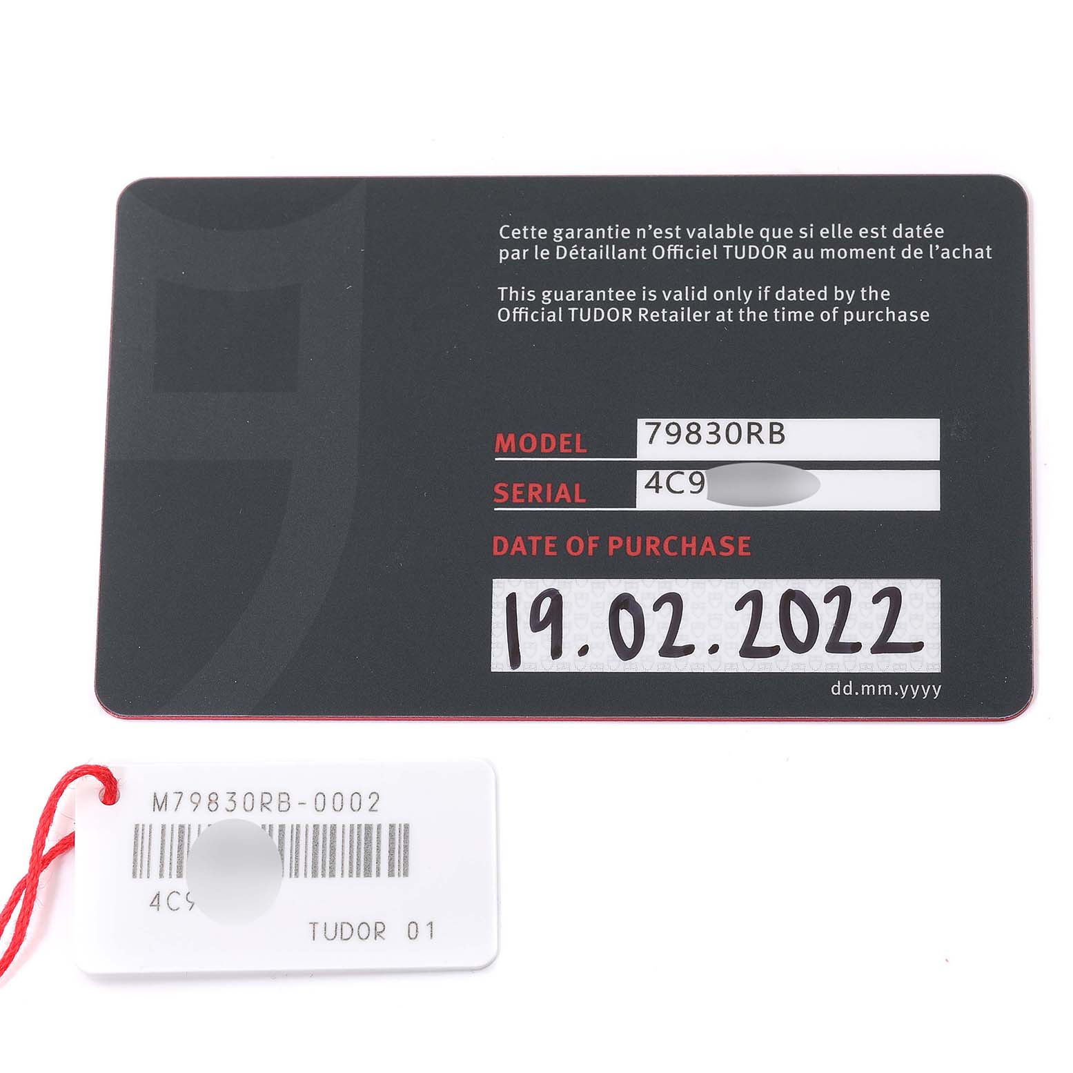 The image shows a warranty card and a tag for a Tudor Heritage Black Bay 79830RB Men
s Stainless Steel Black Dial 79830RB Men
s Stainless Steel Black Dial model 79830RB, with the purchase date listed as 19.02.2022.
