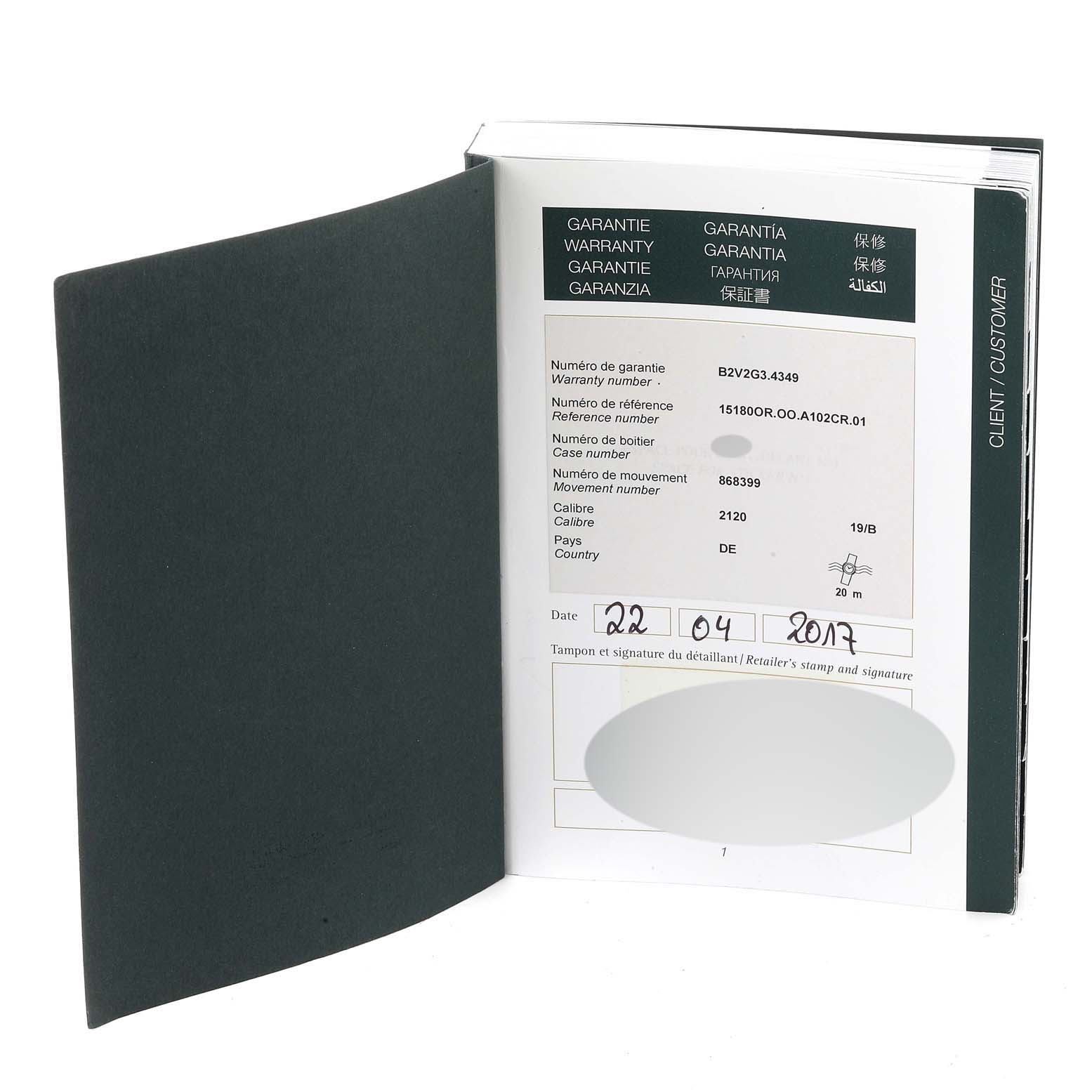 This image shows an open warranty booklet for a Jules model watch by Audemars Piguet, displaying warranty details and a purchase date.